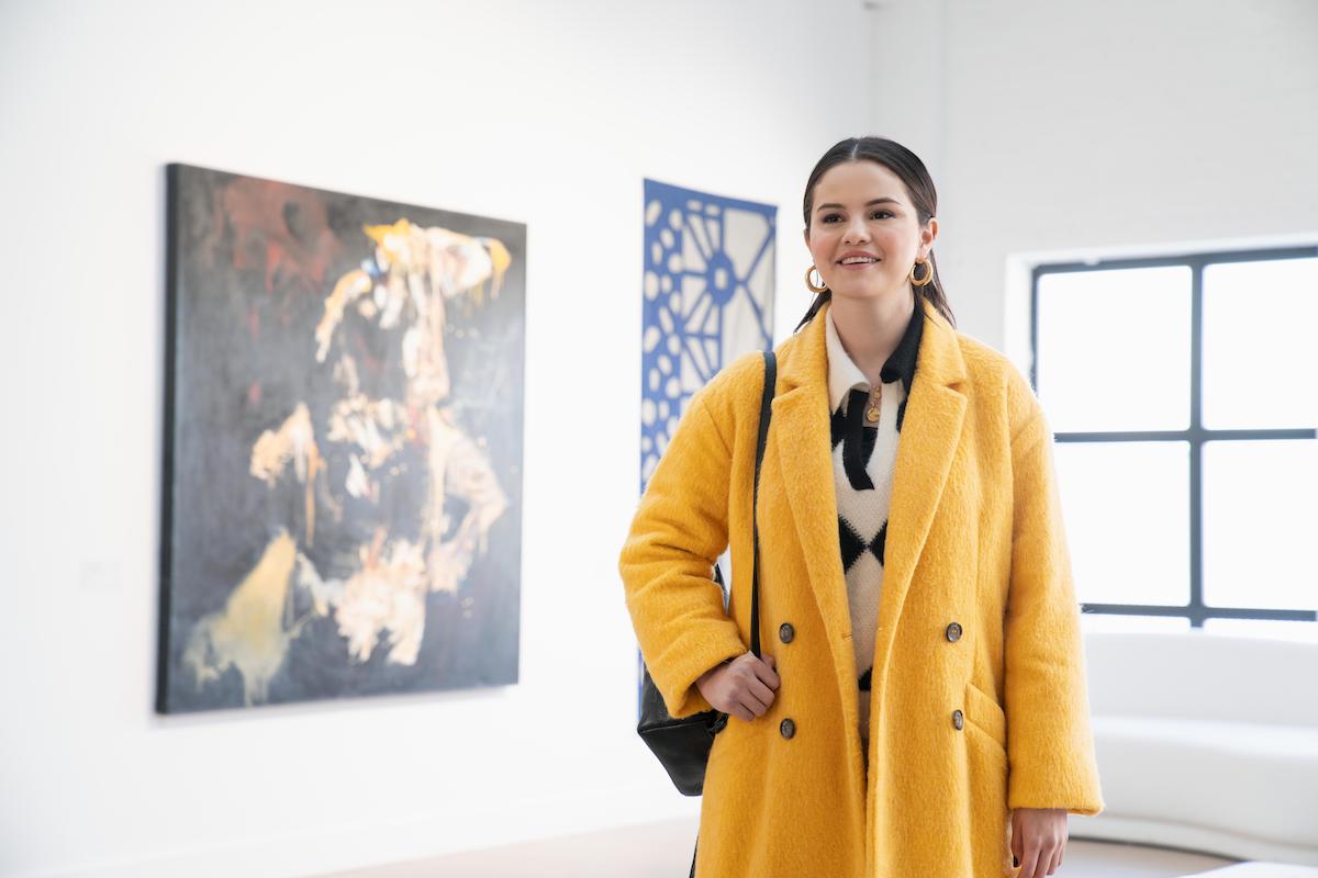 'Only Murders in the Building': Selena Gomez wears a yellow coat in the art gallery as Mabel, whom she says is Alex Russo of 'Wizards of Waverly Place' all grown up