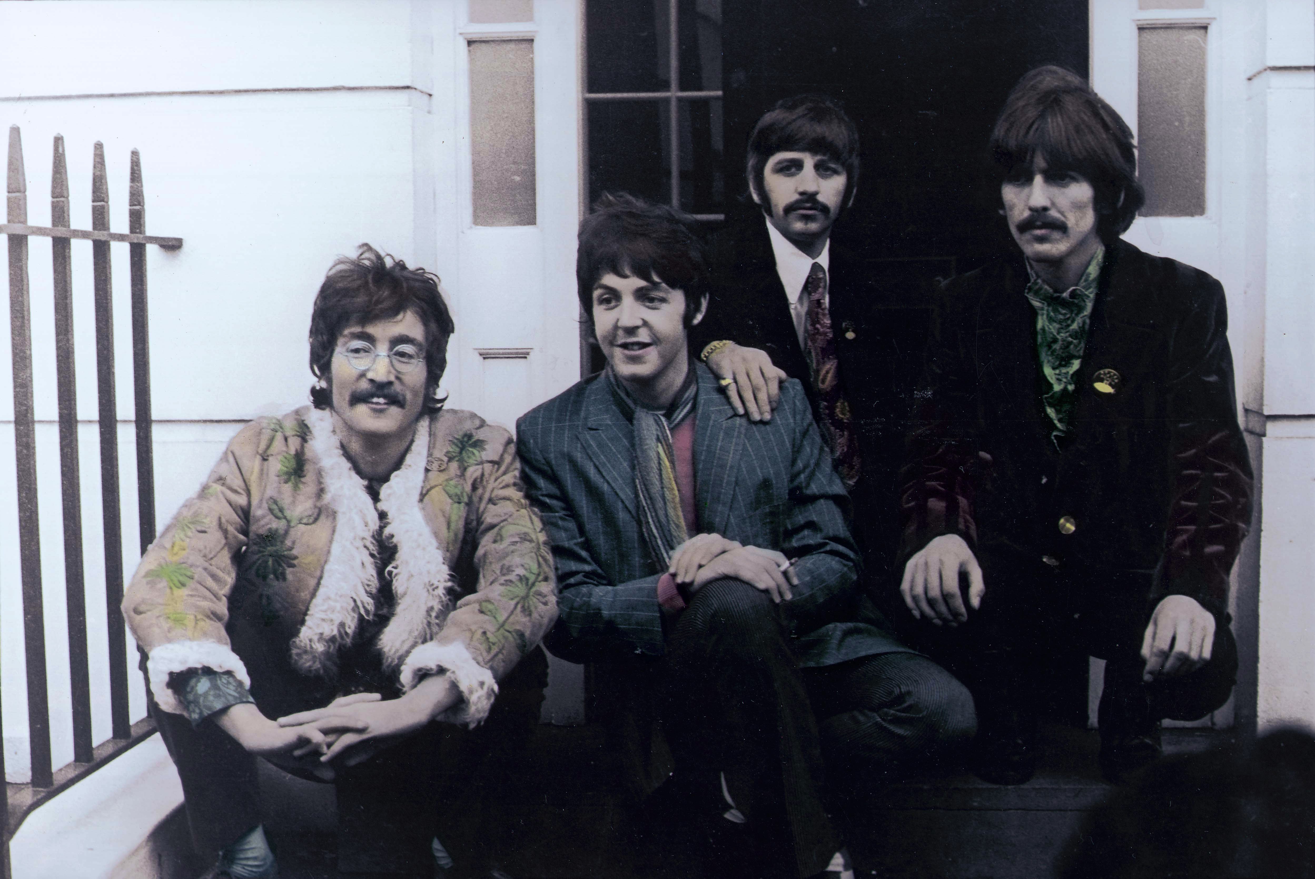 The Beatles' John Lennon, Paul McCartney, Ringo Starr, George Harrison on steps during the "Get Back" era