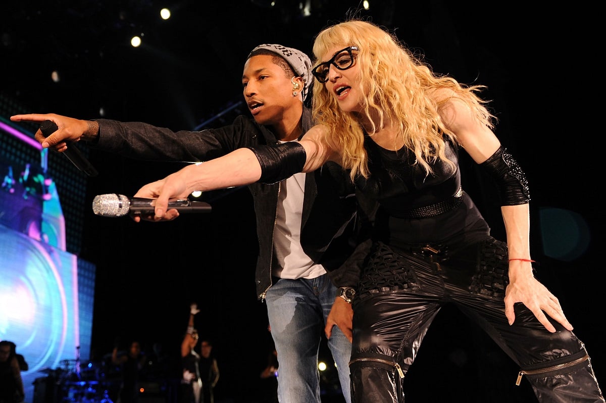 Madonna and Pharrell Williams performing on stage.