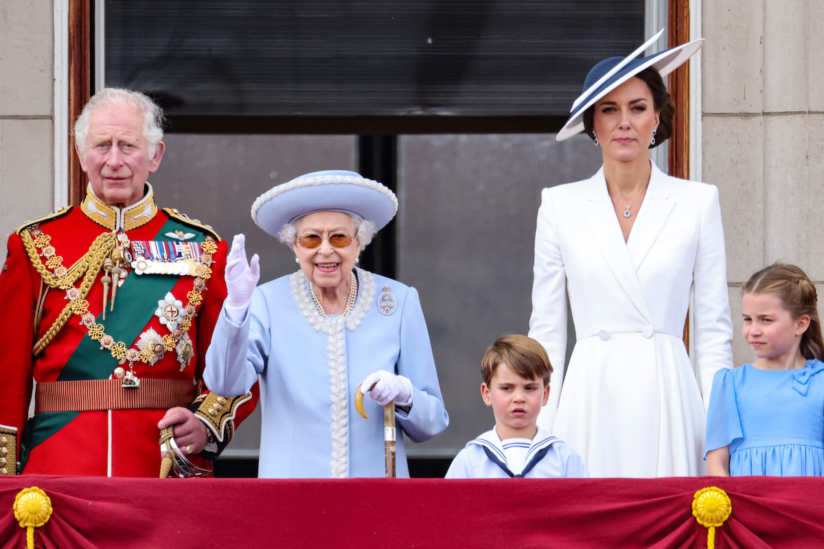 Queen Elizabeth II, who served a 'bitter pill' to Meghan Markle and Prince Harry when she didn't take a photo with Lili, stands on the balcony with Prince Charles, Kate Middleton, and Prince Louis
