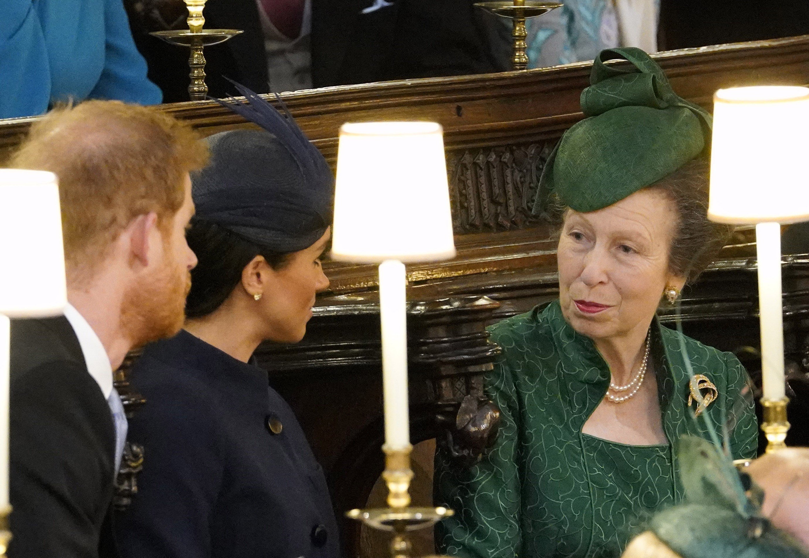 Prince Harry, Meghan Markle, and Princess Anne, who a Physic says 'saw straight through' the duchess, in their seats at Princess Eugenie's wedding
