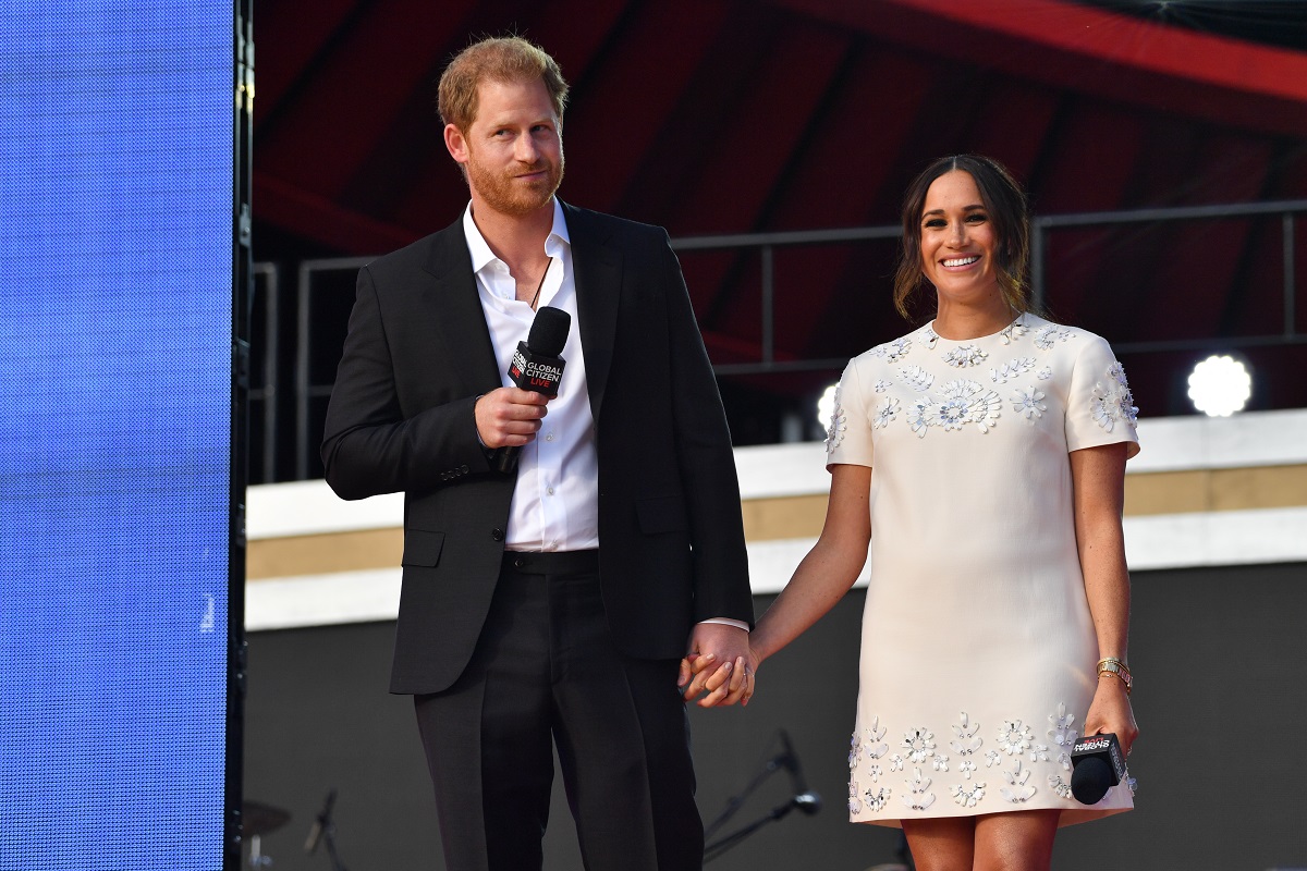 Prince Harry and Meghan Markle, who relationship Princess Diana's butler finds concerning, holding hands onstage at Global Citizen Live in New York City