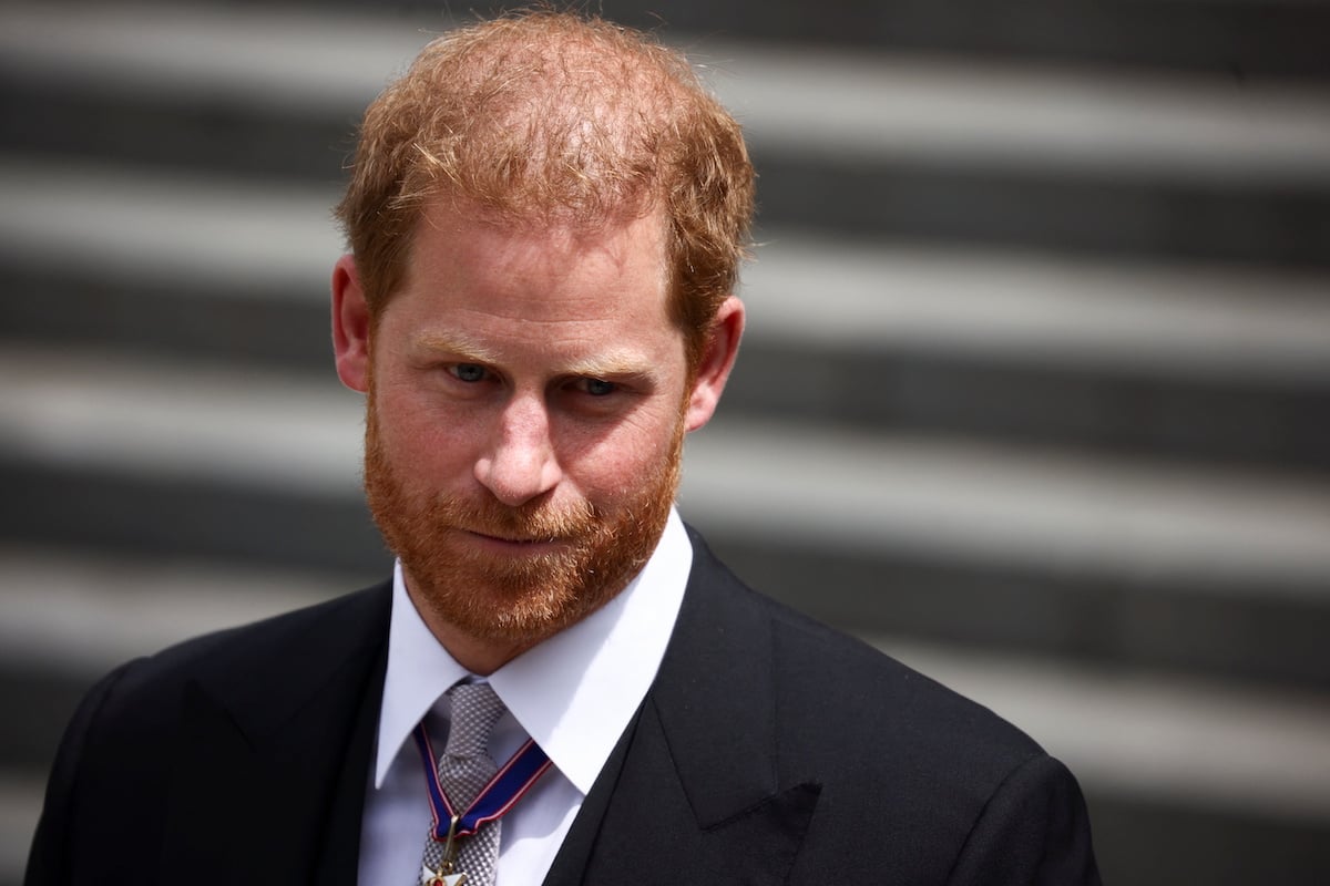 Prince Harry frown and looks away from the sun.