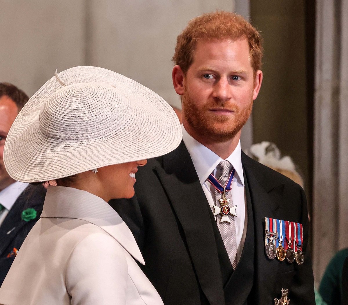Prince Harry, who a royal author claims is experiencing "self-inflicted" pain, leaving St Paul's cathedral with Meghan Markle after service