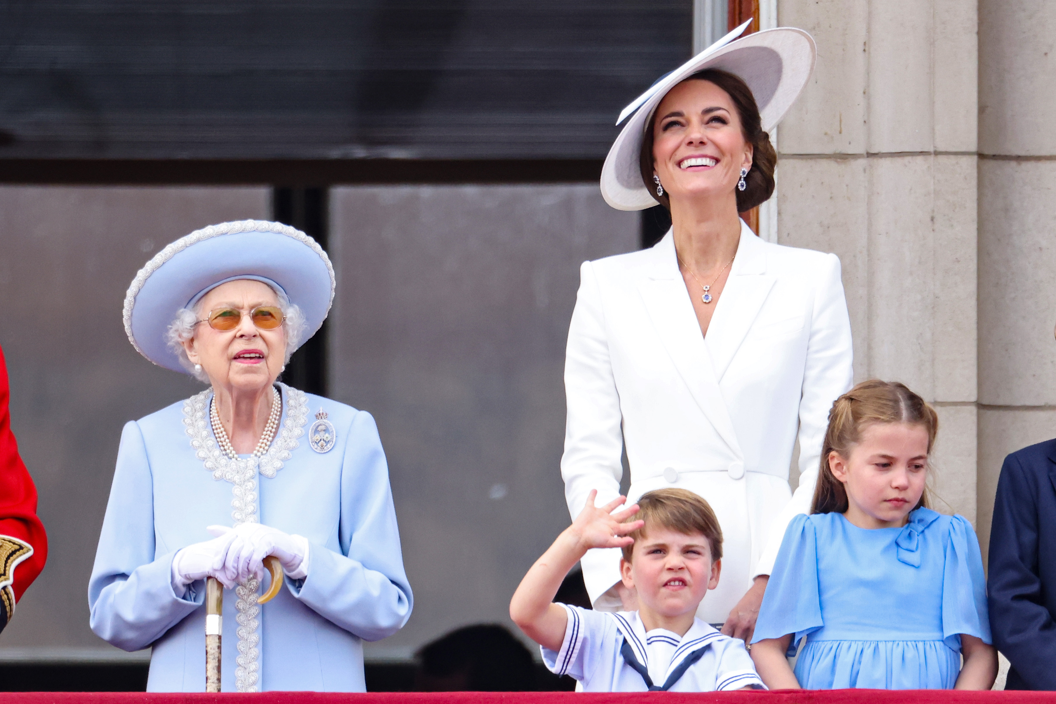 Queen Elizabeth II, Prince Louis, Catherine, Duchess of Cambridge, and Princess Charlotte observing the Trooping the Colour parade from the Buckingham Palace balcony