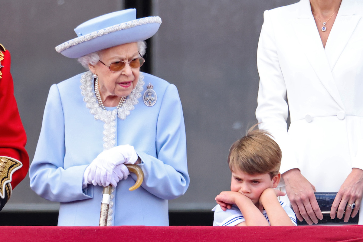 Queen Elizabeth II and Prince Louis, whose Platinum Jubilee weekend antics got a response from Kate Middleton and Prince William, stand on the balcony of Buckingham Palace