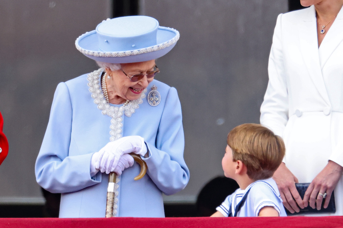 Queen Elizabeth II smiles as Prince Louis speaks while on the Buckingham Palace balcony