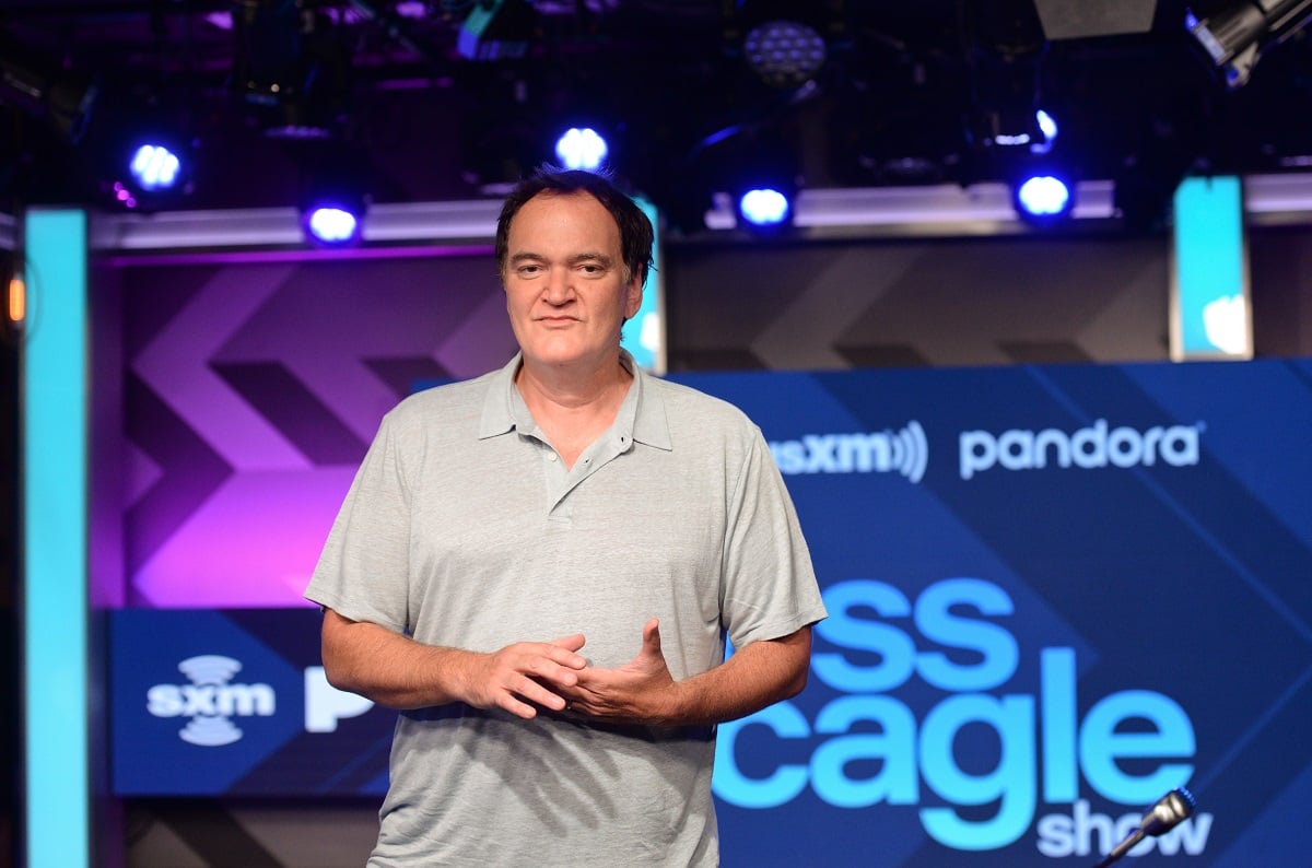 Quentin Tarantino posing while wearing a blue shirt.