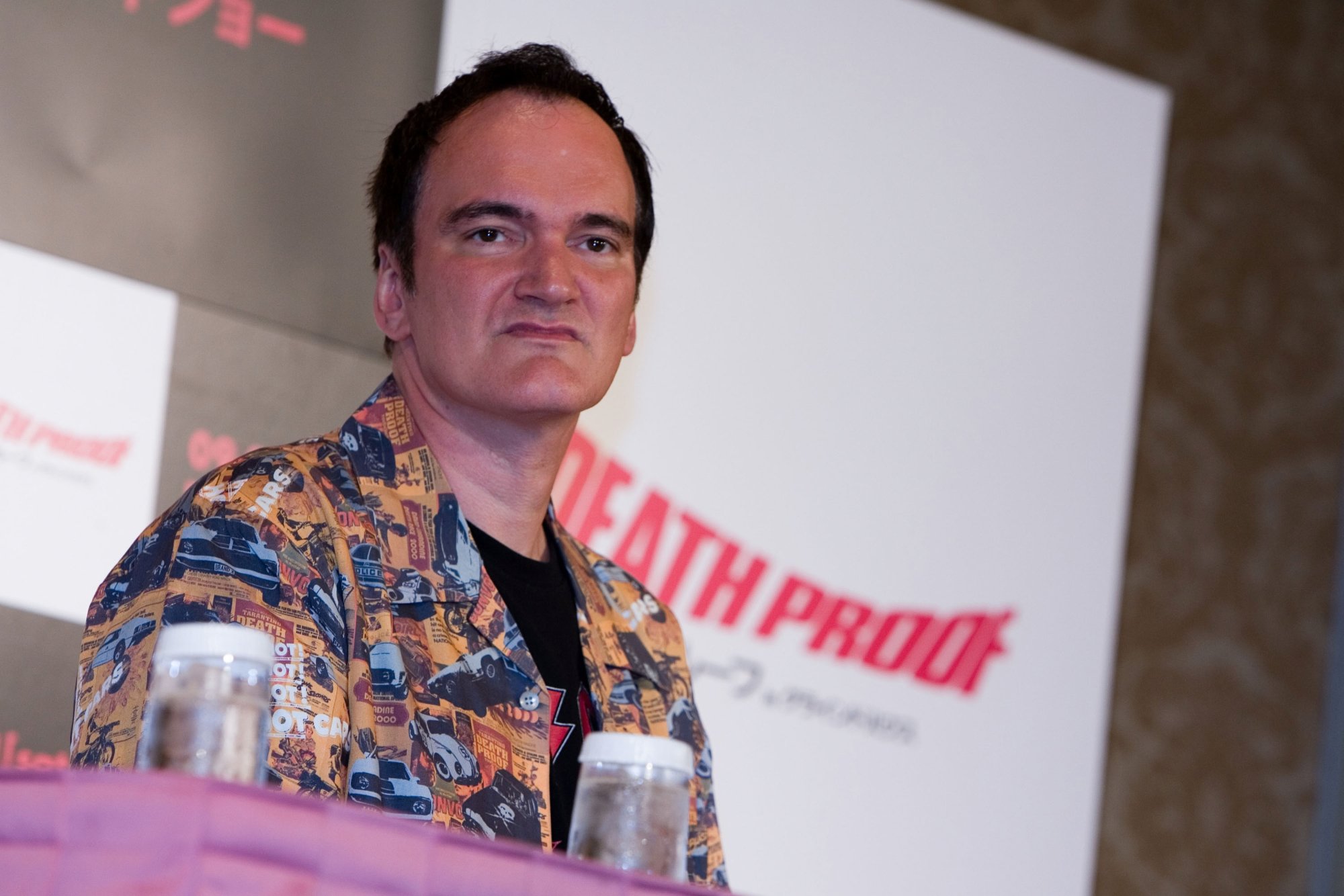 Quentin Tarantino, who fans say has a foot fetish, wearing a button-up shirt on a panel
