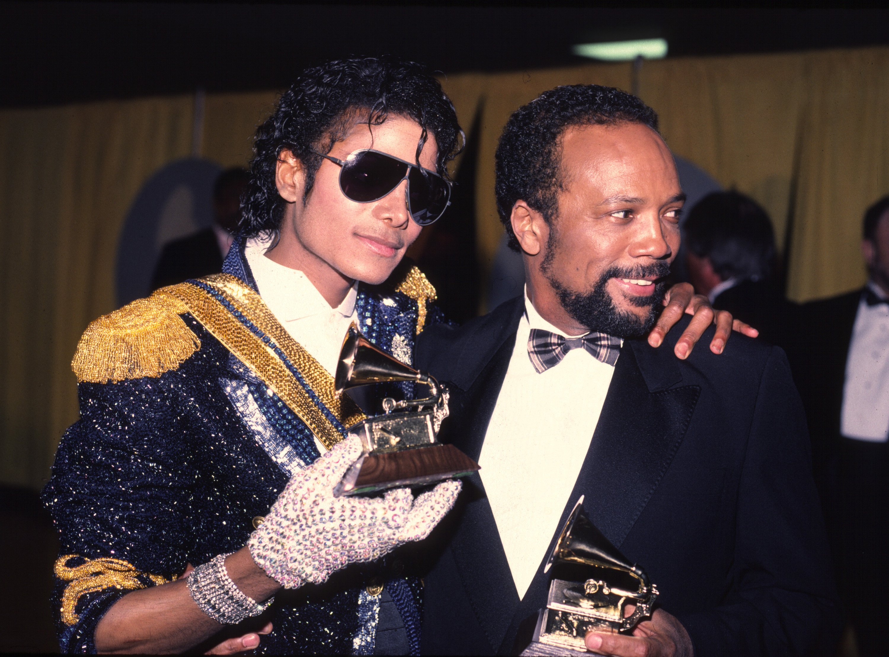 Michael Jackson putting his arm around Quincy Jones