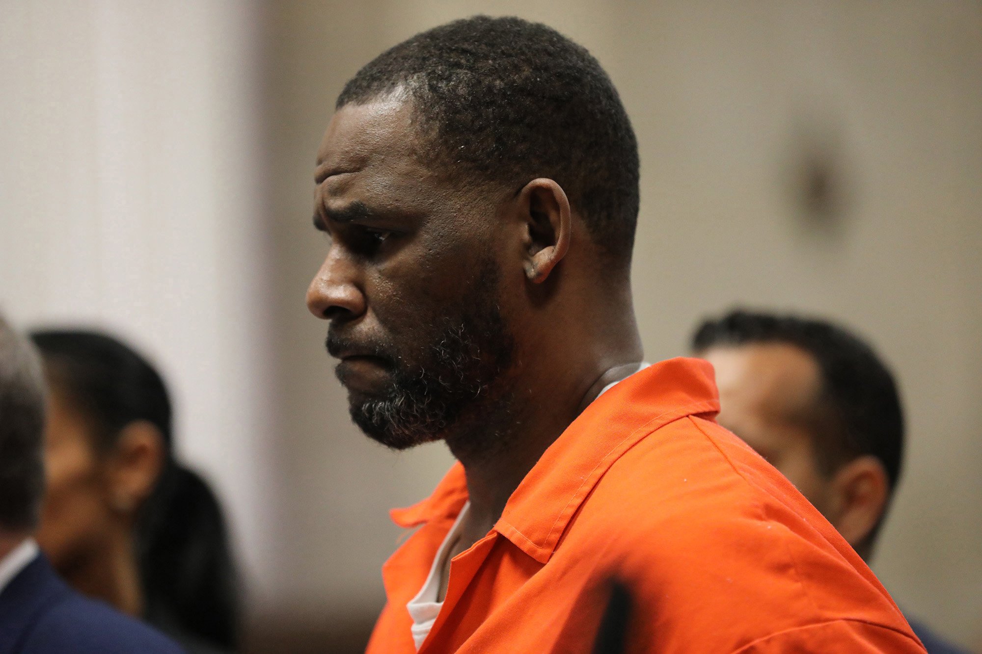 R. Kelly, sentenced to 30 years in prison, appears in court wearing an orange jumpsuit.