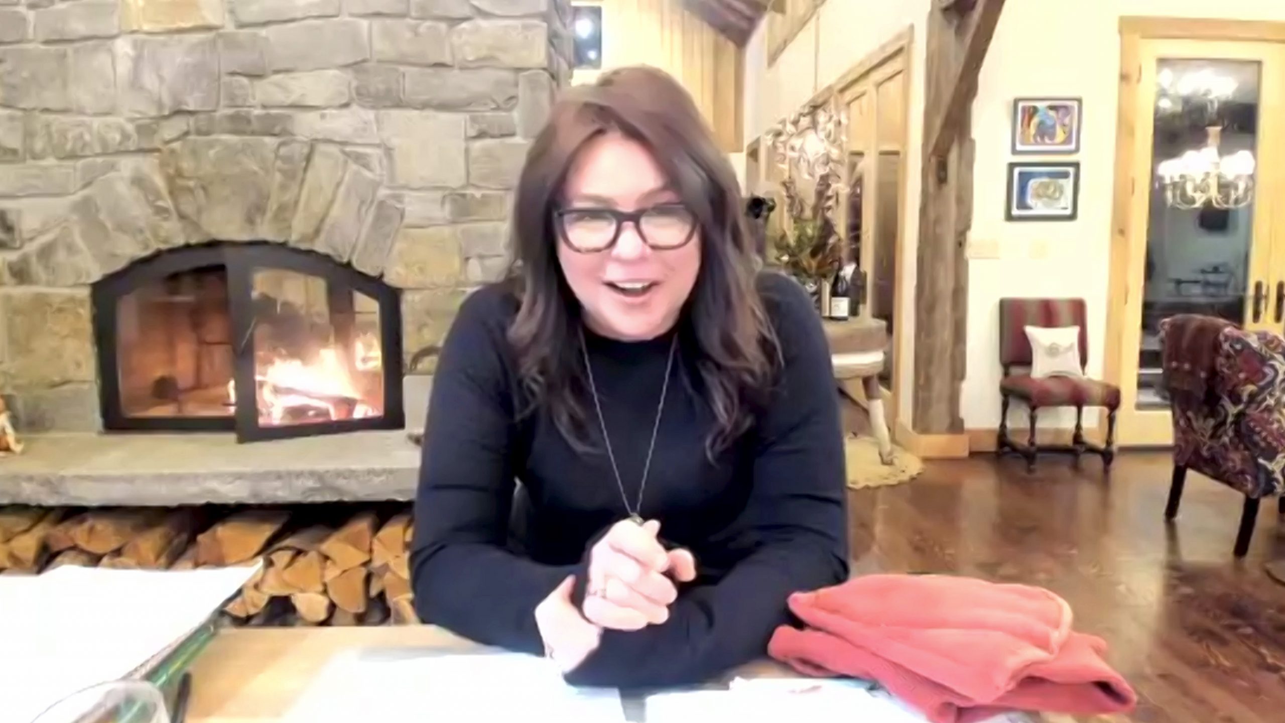 Celebrity chef Rachael Ray wears a long-sleeved black blouse in this photograph.
