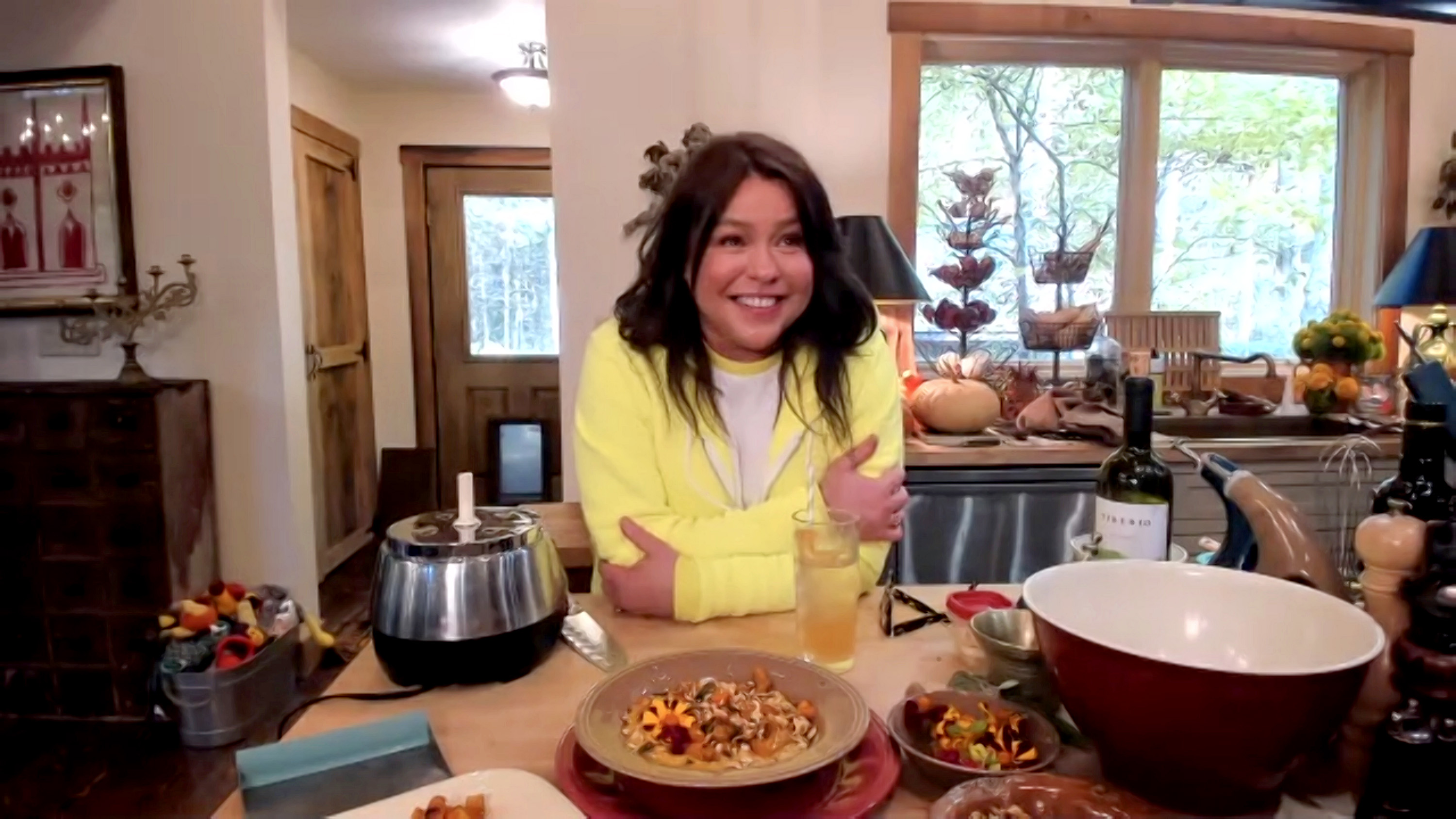 Celebrity chef Rachael Ray wears a yellow cardigan in this photograph.