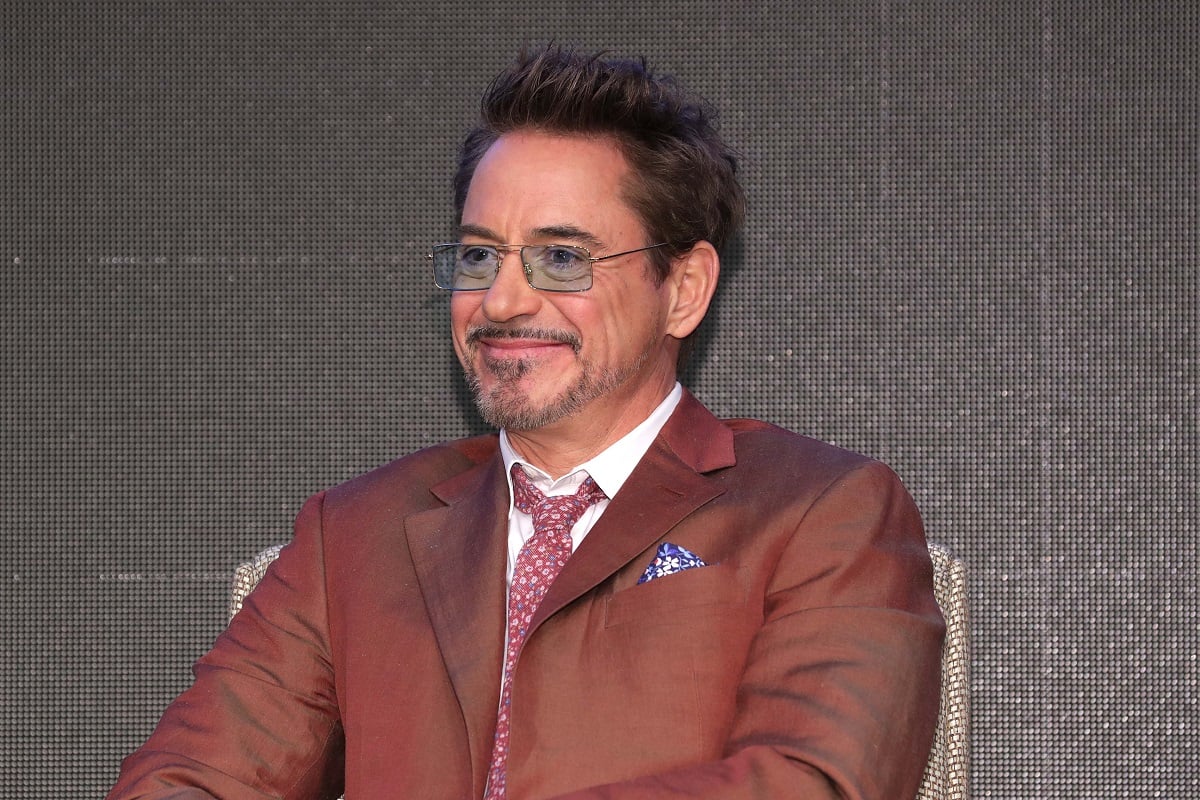 Robert Downey Jr. smiling while wearing a brown suit.