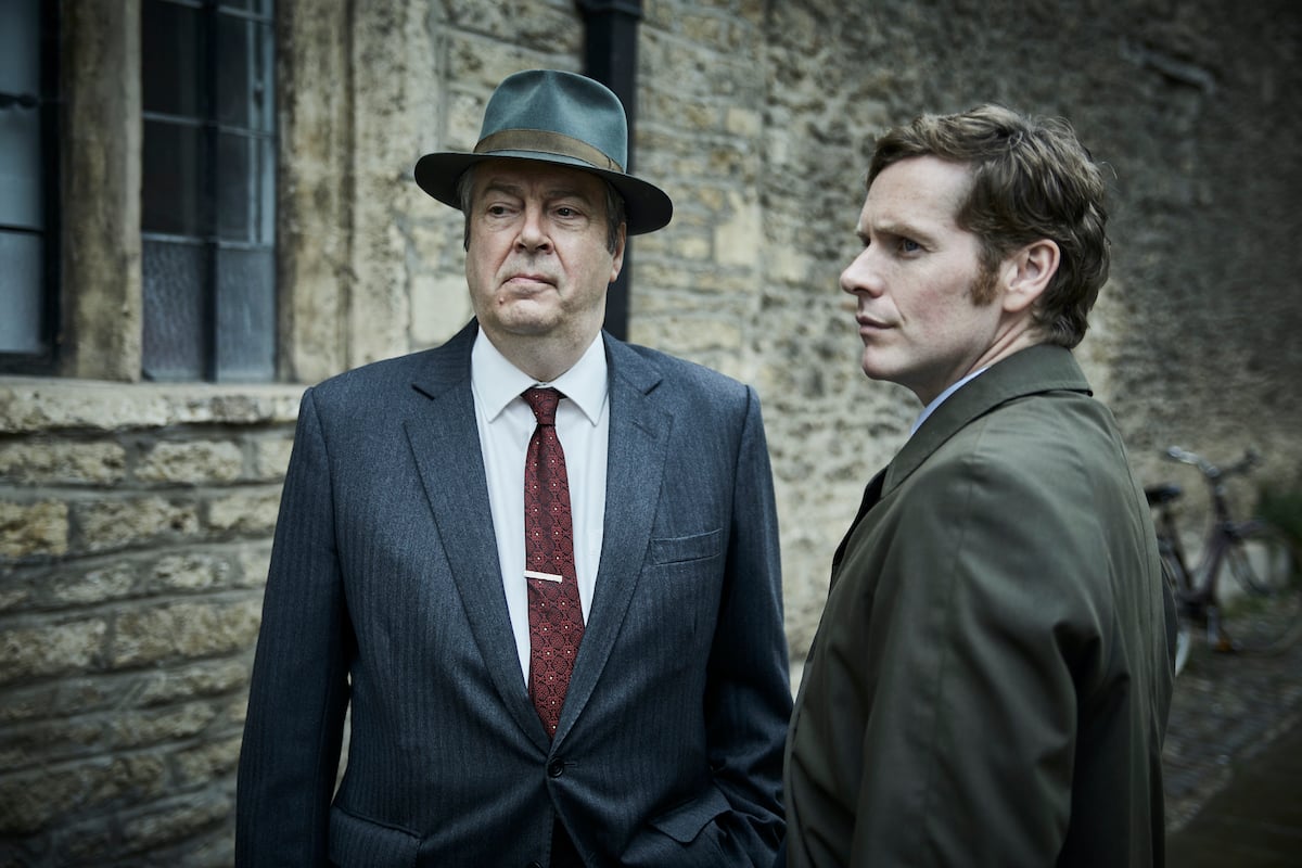 Roger Allam as Fred Thursday, wearing a hat, and Shaun Evans, standing in profile, as Morse in PBS's 'Endeavour'