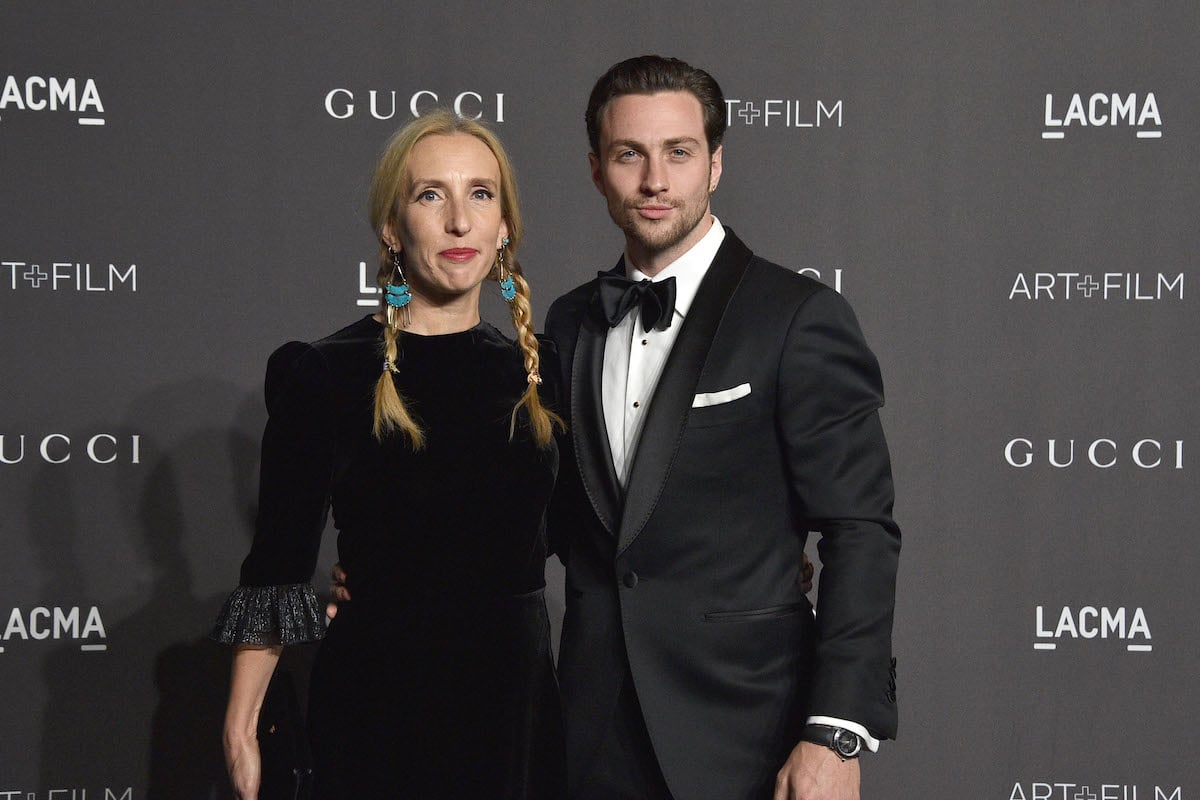 Sam Taylor-Johnson and Aaron Taylor-Johnson pose together at an event.