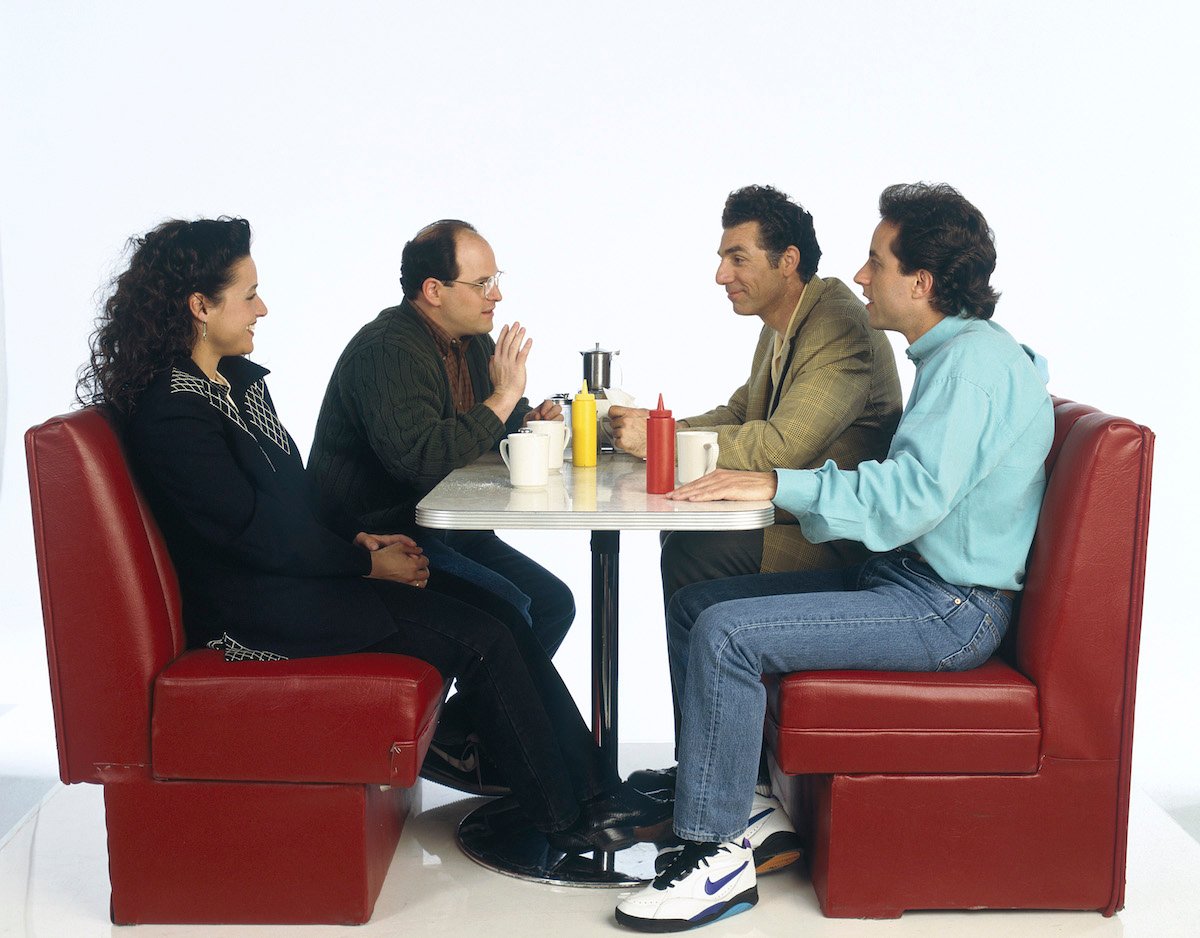 'Seinfeld' cast members sitting in a restaurant booth