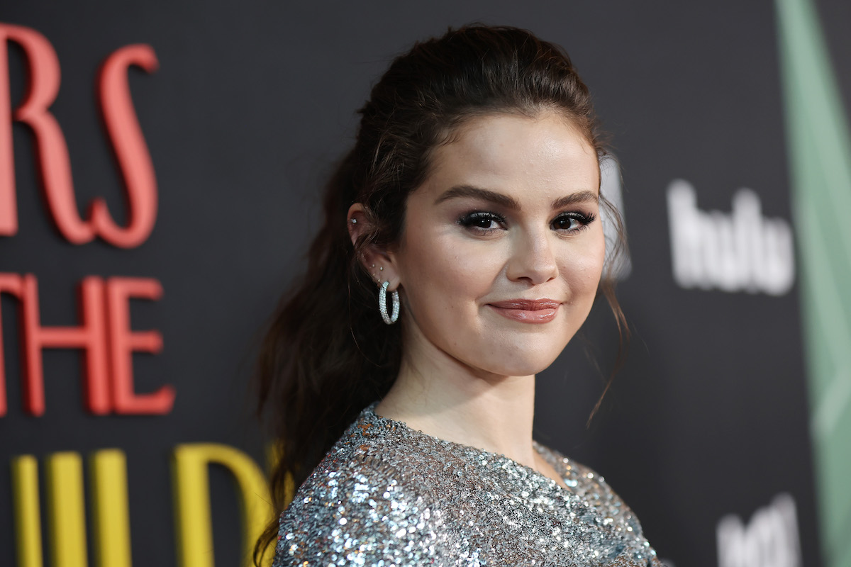 Selena Gomez smiles and poses at an event.