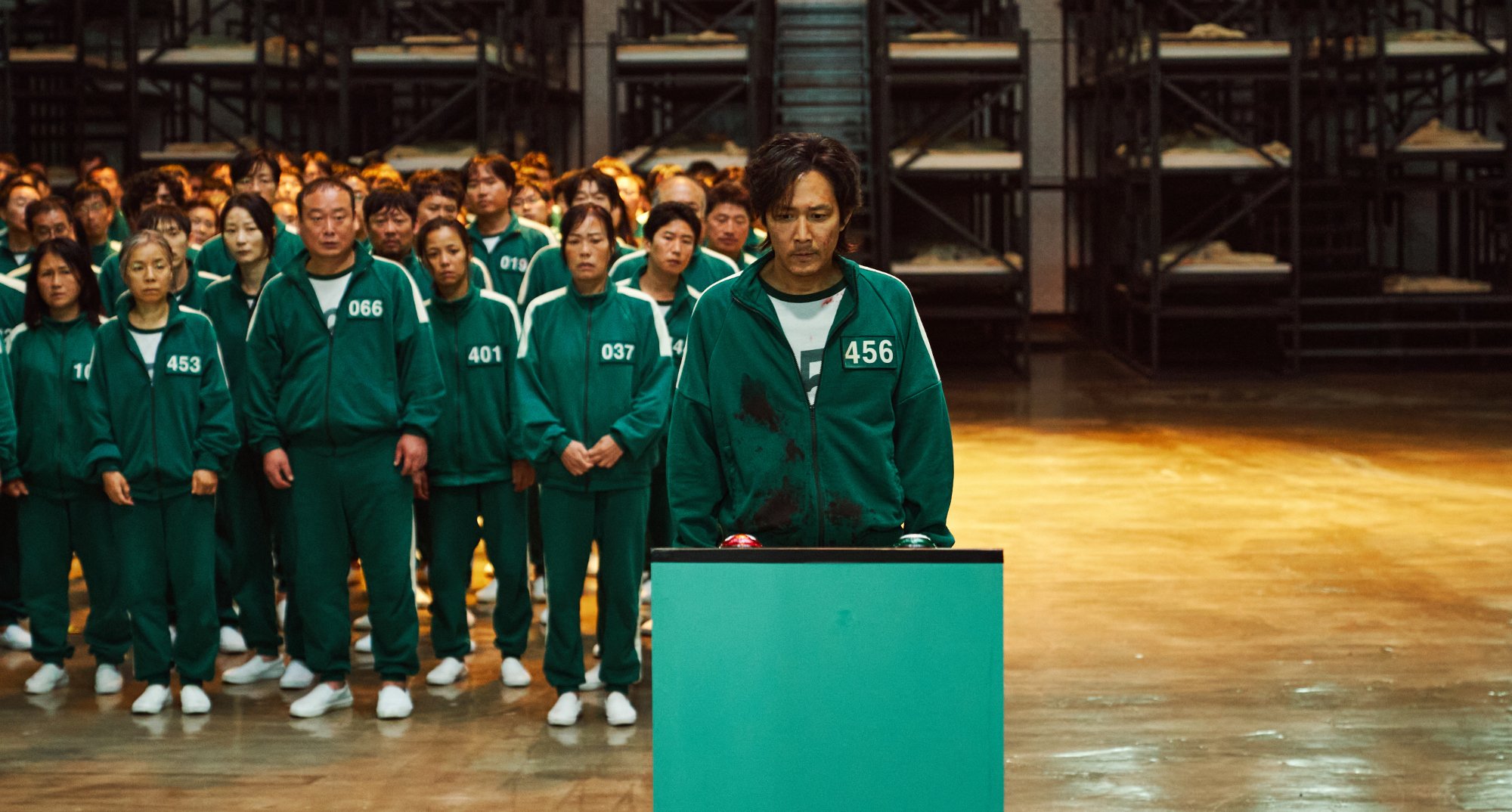 Seong Gi-hun in 'Squid Game' Episode 2 in relation to fan reactions for 'Squid Game The Challenge'