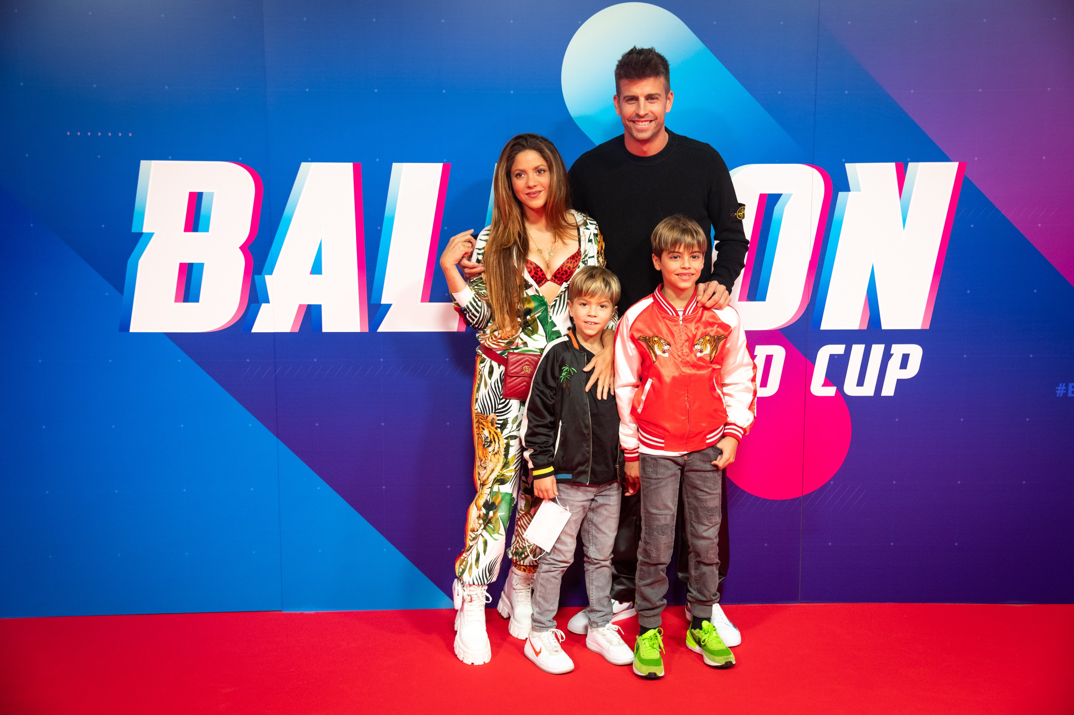 Shakira, Gerard Pique, and their two sons smile on the carpet at the balloons world cup