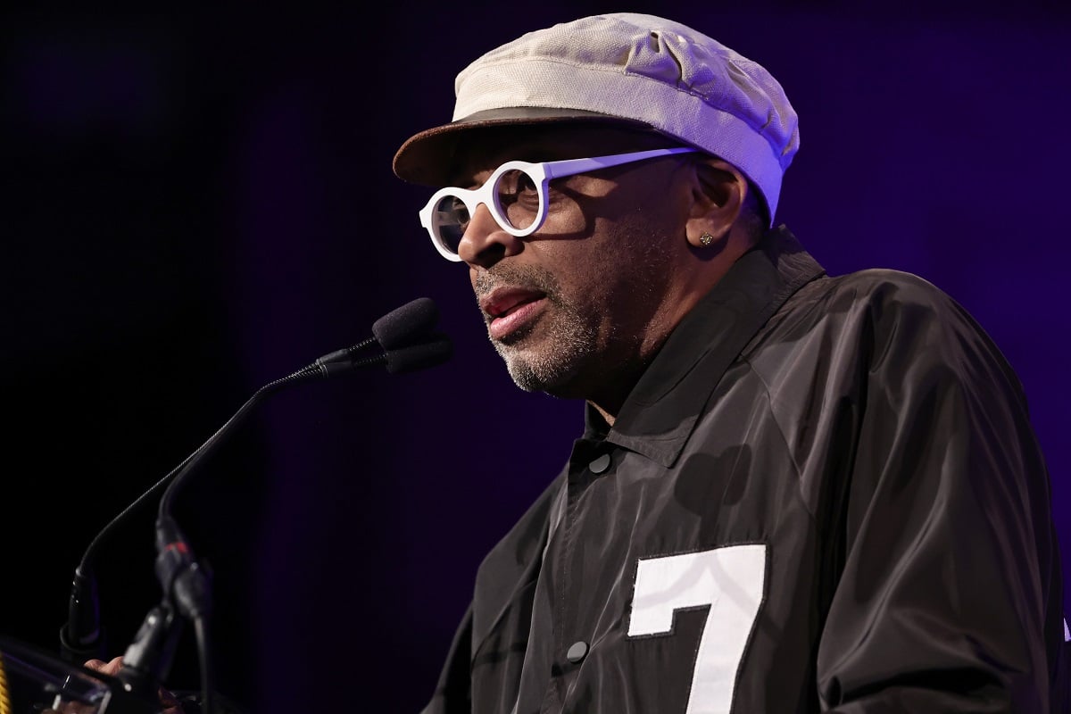 Spike Lee standing behind a podium and speaking into a microphone.