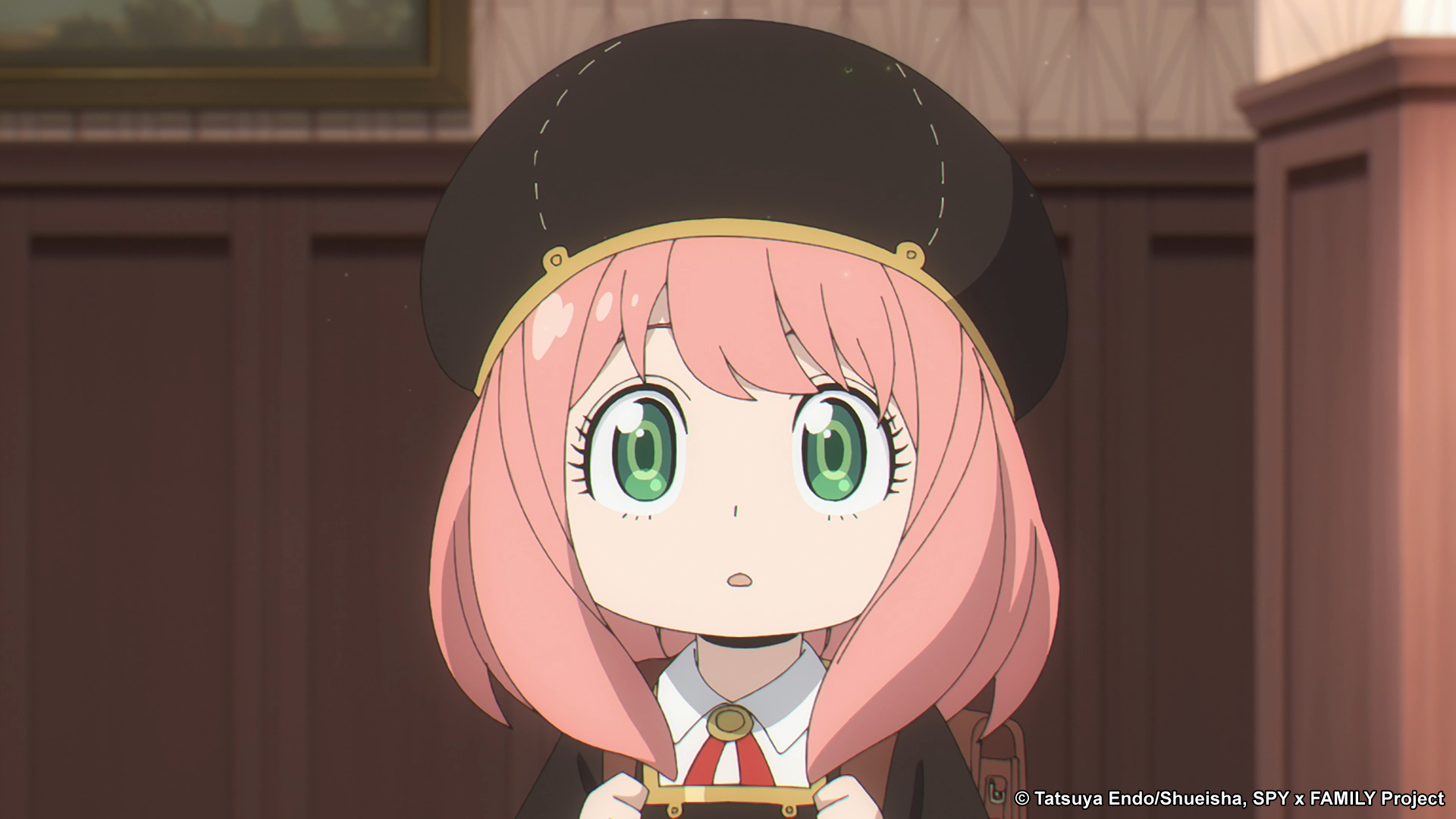 Anya Forger in her Eden College uniform, which she wears in 'Spy x Family' Episode 10. It's black and gold and includes a round hat.