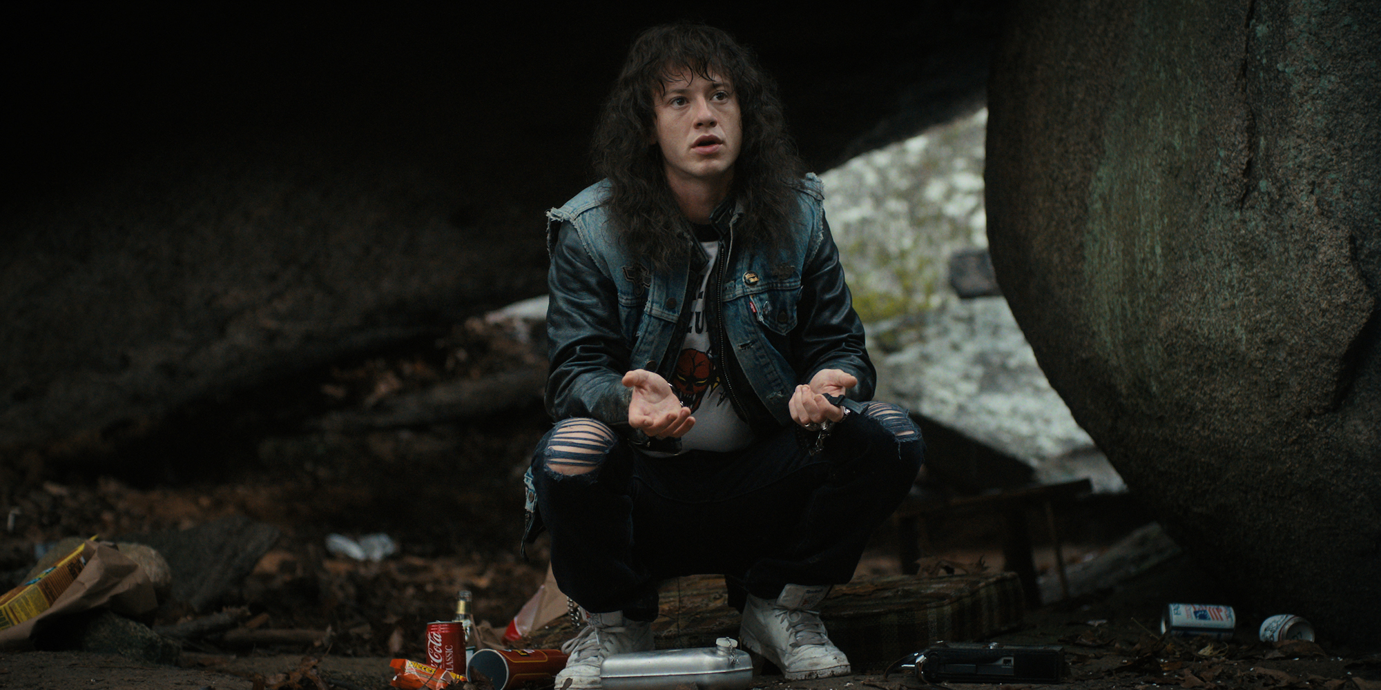 'Stranger Things 4' Eddie Munson, played by Joseph Quinn, wears a Hellfire Club tshirt in a production still.