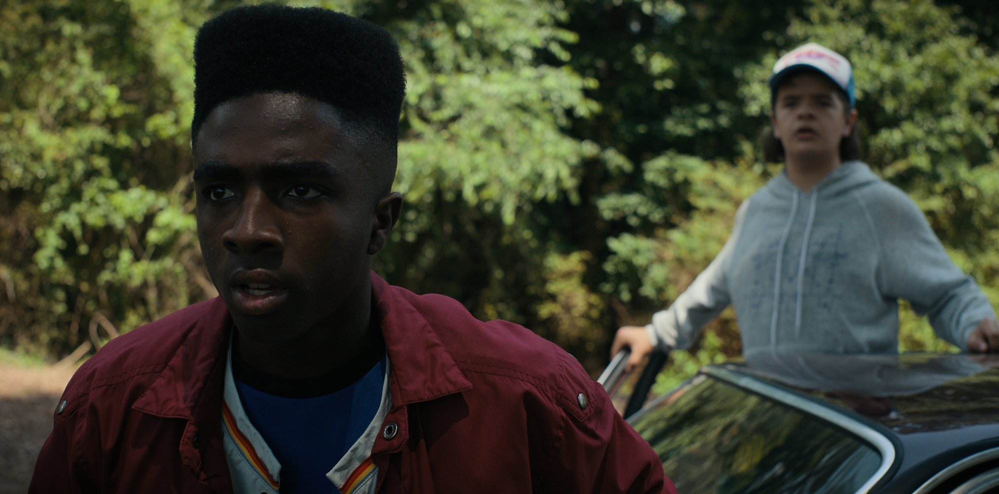 'Stranger Things 4' fan theories have star Caleb McLaughlin, seen here in a production still wearing a maroon jacket, thinking people need to relax.
