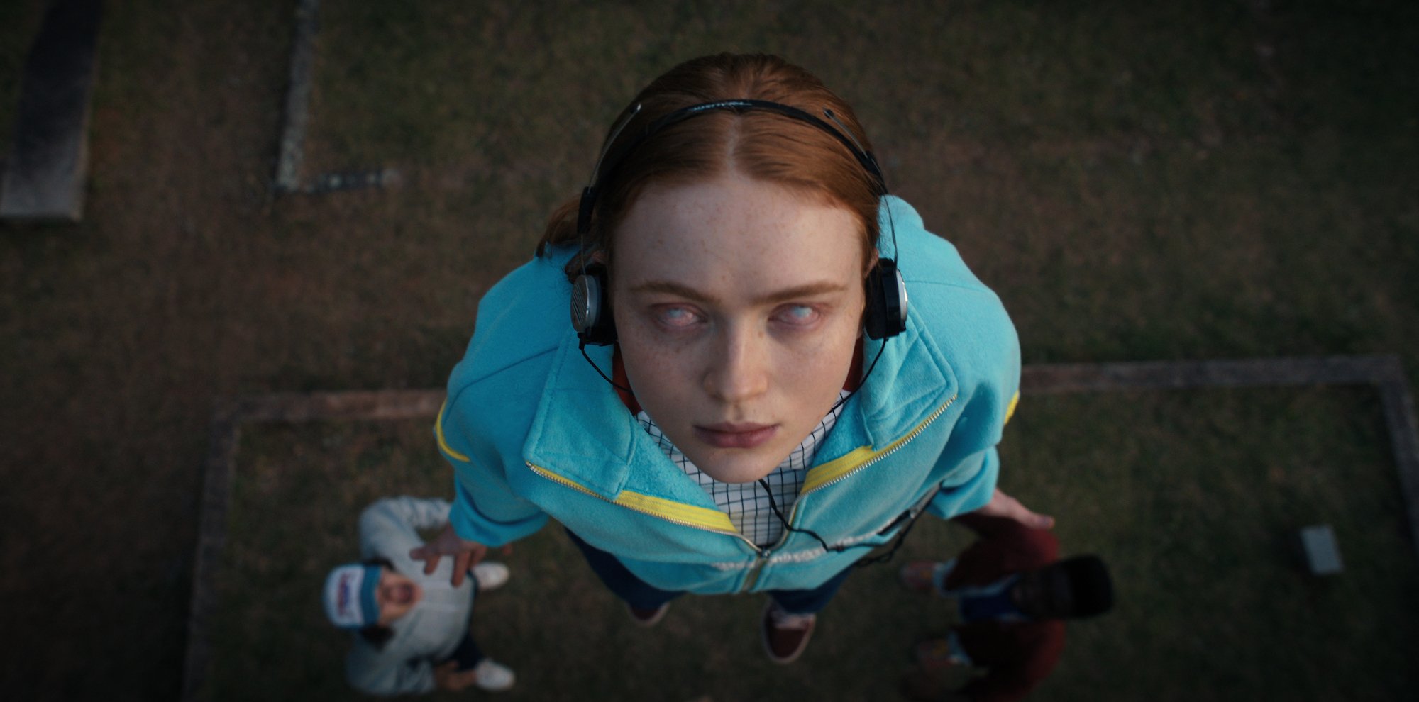 Stars Gaten Matarazzo and Caleb McLaughlin might have accidentally leaked that Lucas is targeted by 'Stranger Things 4' villain Vecna in volume II. Here, Sadie Sink as Max, levitates wearing white contacts in a production still.