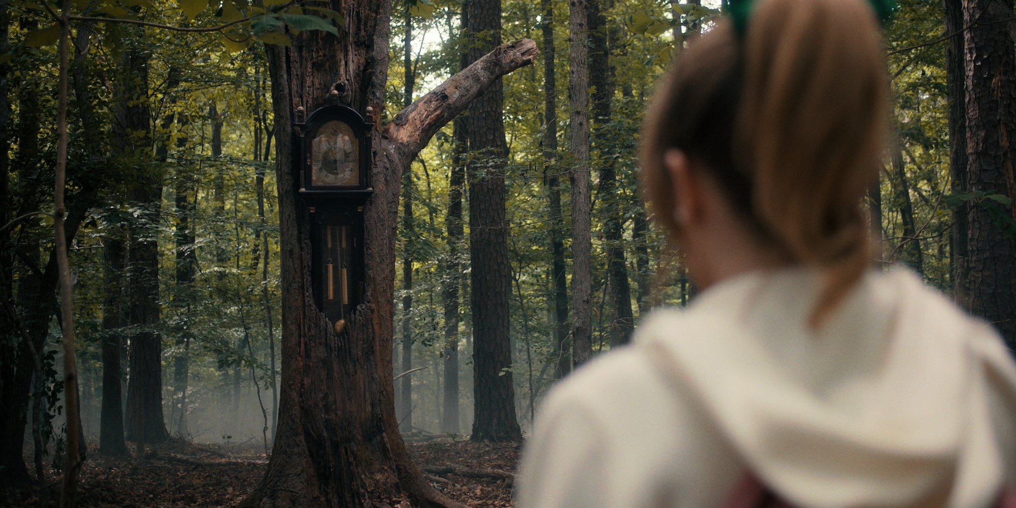 'Stranger Things 4' villain Vecna makes a clock appear hours before he kills his victims. Grace Van Dien as Chrissy Cunningham sees the clock in the woods in this production still
