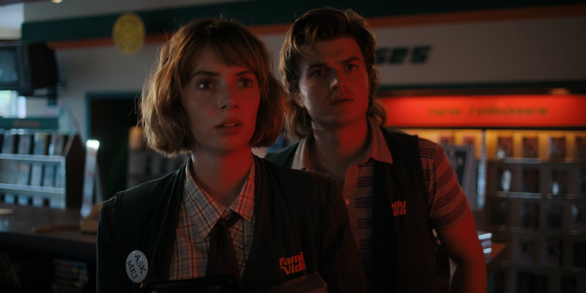 Maya Hawke as Robin Buckley and Joe Keery as Steve Harrington in Stranger Things. Robin and Steve wear their Family Video vests.