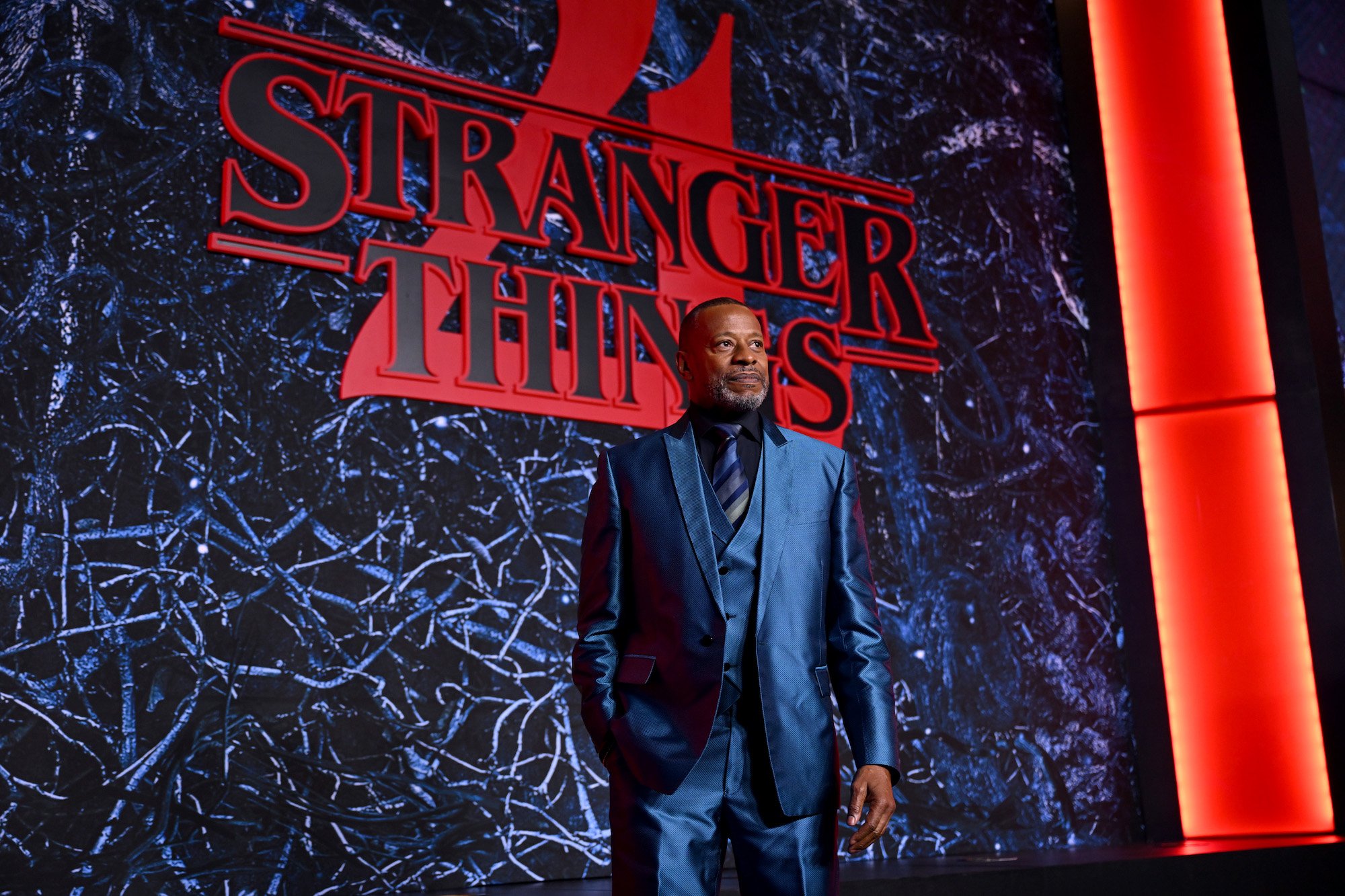 'Stranger Things 4' actor Sherman Augustus attends the world premiere in NYC while wearing a blue suit and tie.