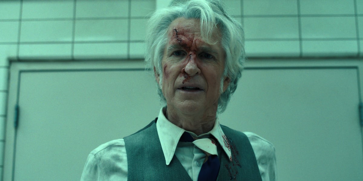 Matthew Modine as Dr. Martin Brenner in Stranger Things Season 4. Dr. Brenner has a bloody wound on his face. 
