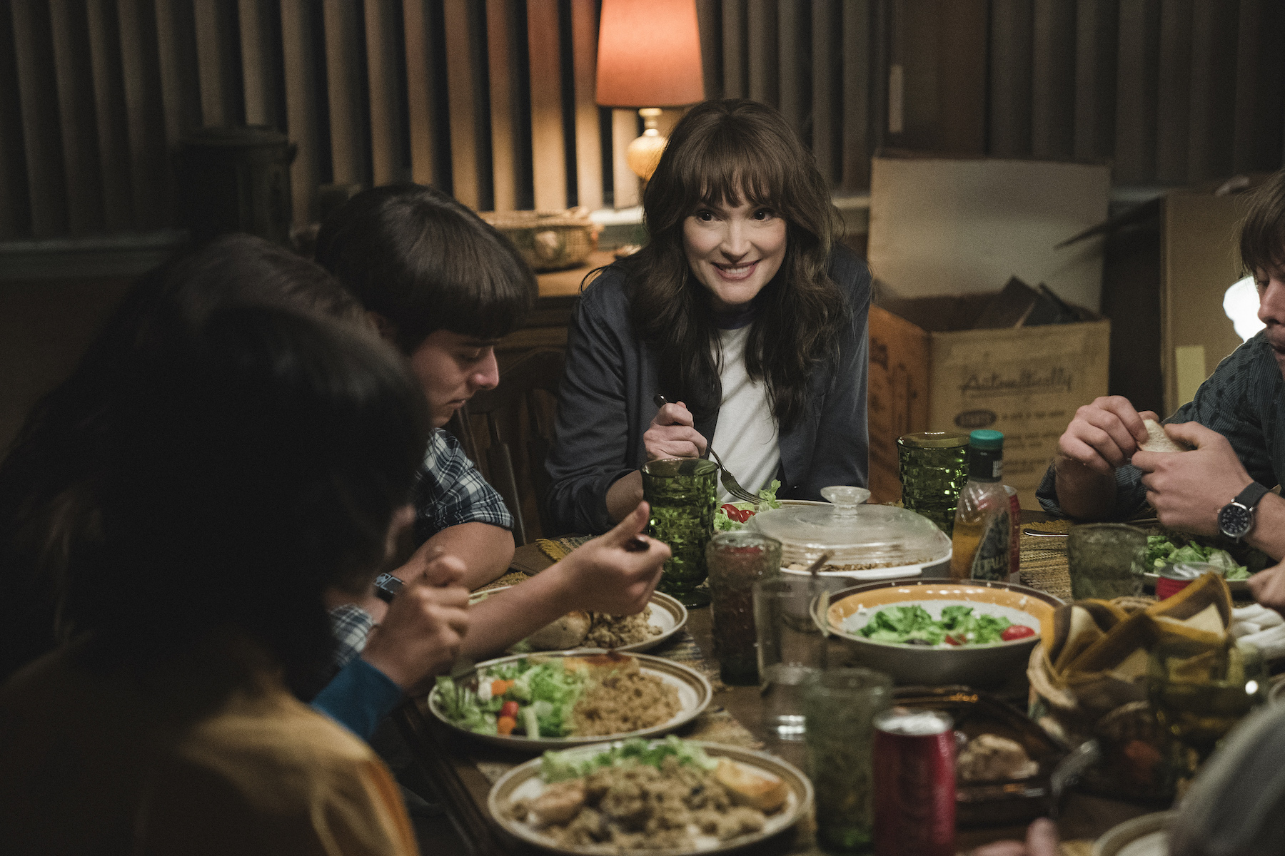 Noah Schanpp as Will Byers and Winona Ryder as Joyce Byers eating dinner together in 'Stranger Things' Season 4