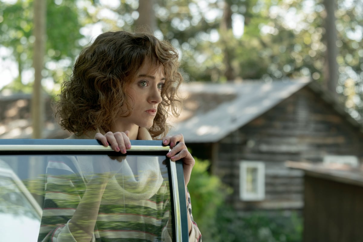 Natalia Dyer as Nancy Wheeler in Stranger Things Season 4. Nancy steps out of her car.