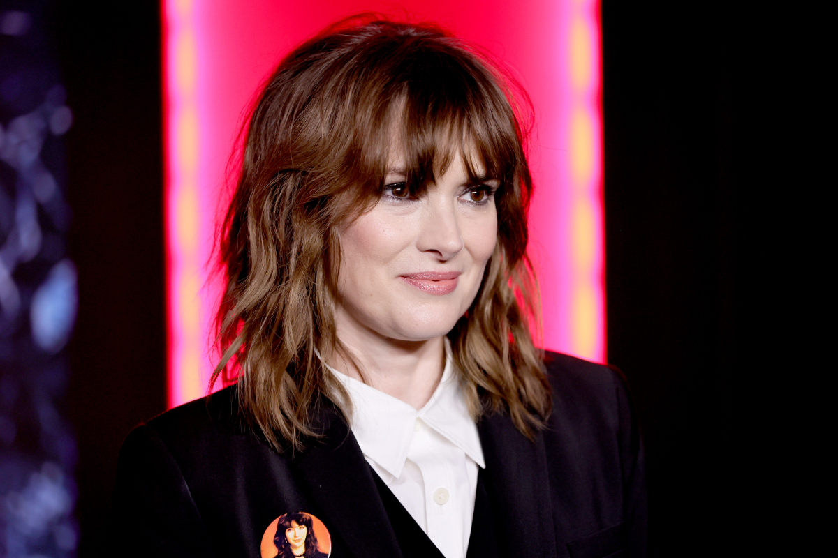 Winona Ryder attends Netflix's Stranger Things Season 4 New York Premiere at Netflix Brooklyn. Ryder wears a white button-up shirt and black jacket.