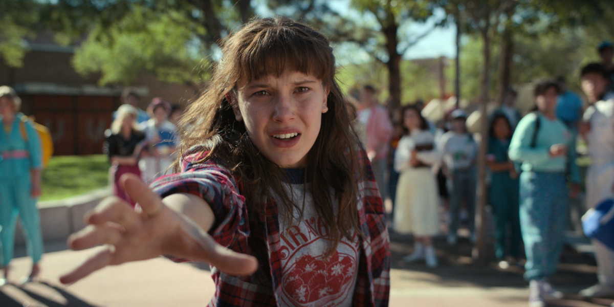 Eleven was a test subject at Hawkins Lab in Stranger Things. Eleven extends her hand outside her school in season 4. 