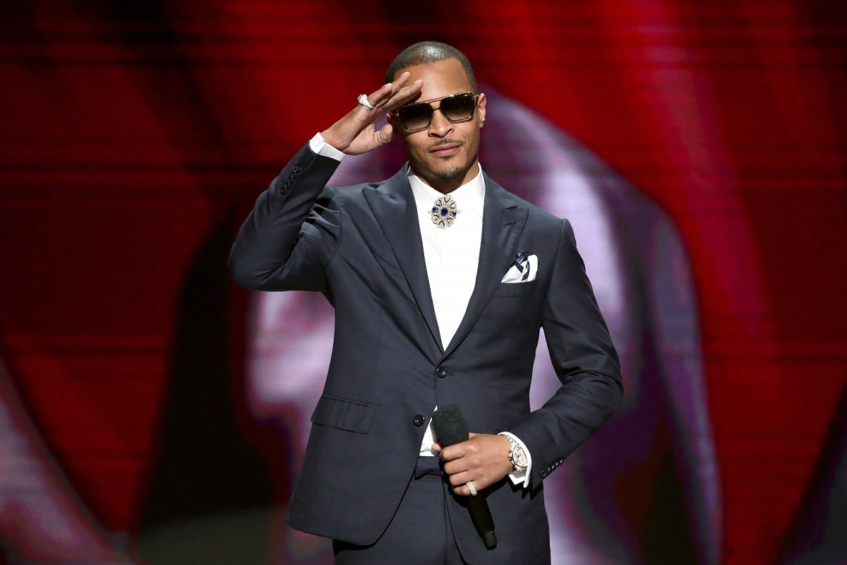 T.I. saluting while wearing a suit.