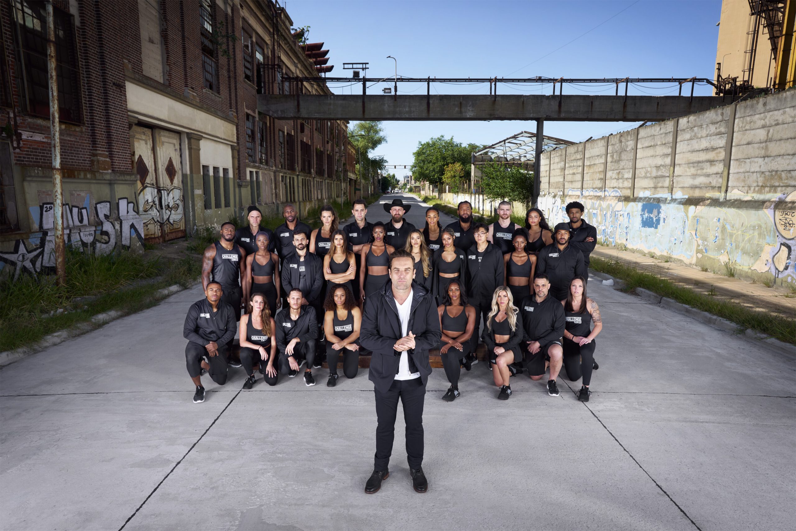 Host TJ Lavin and 'The Challenge: USA' cast posing for cast picture