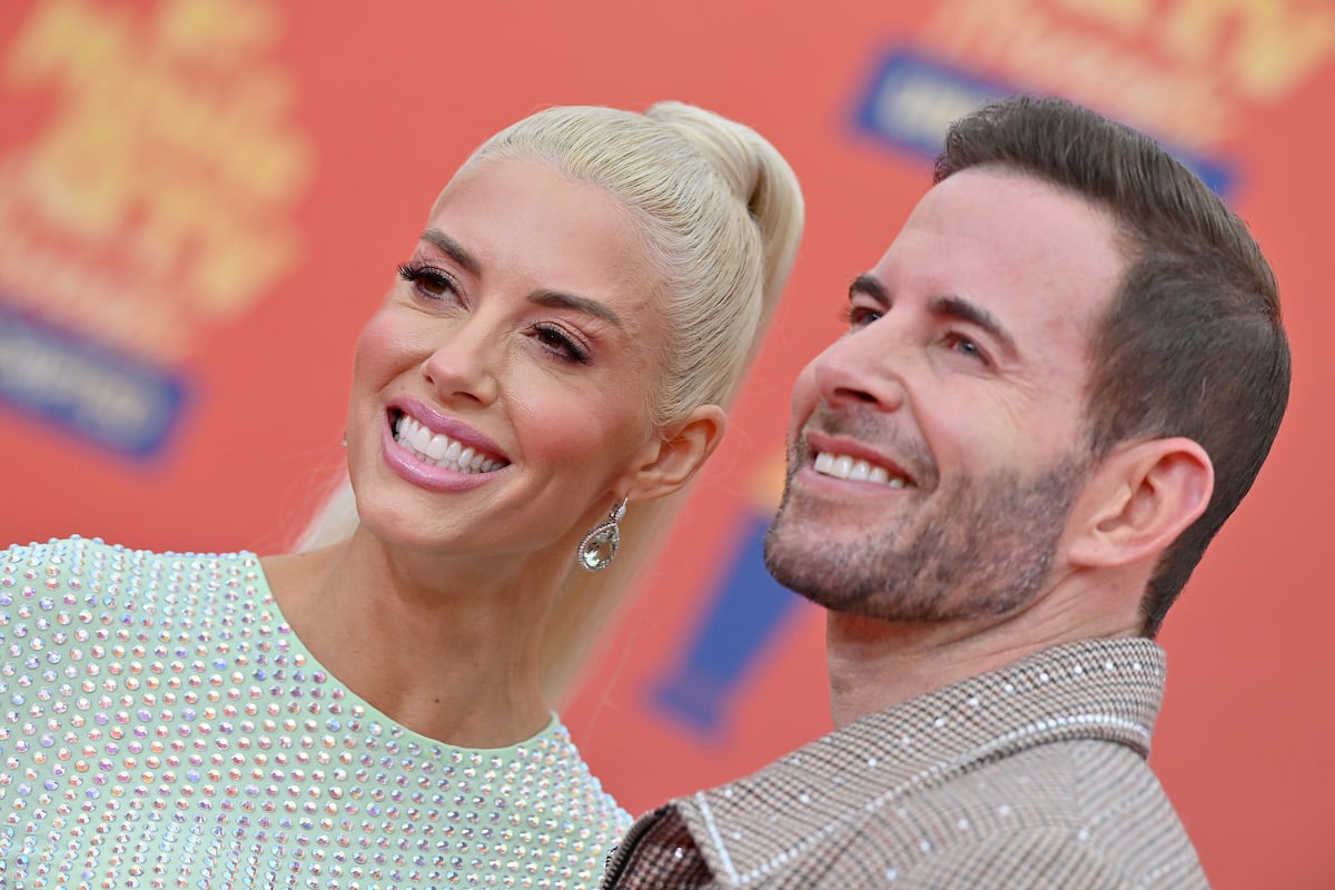 Heather Rae Young and Tarek El Moussa pose together at an event.