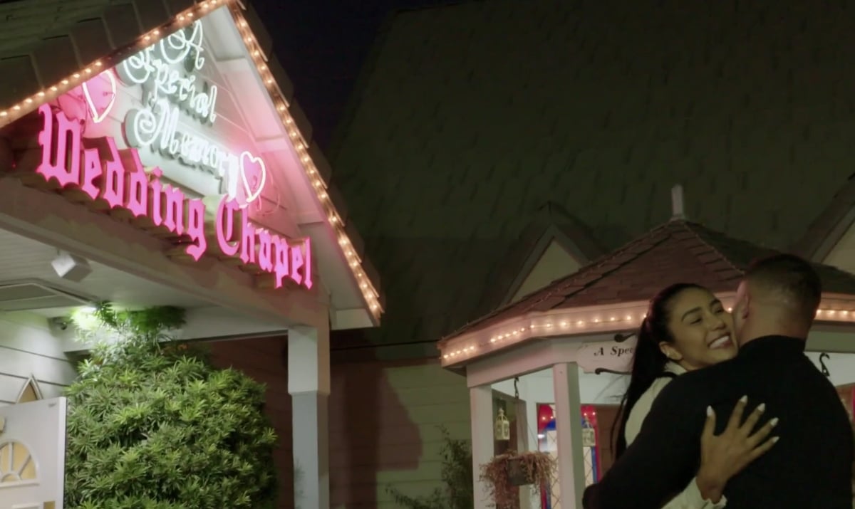 '90 Day Fiancé' couple, Thaís and Patrick hug in front of a wedding chapel in Las Vegas, NV.