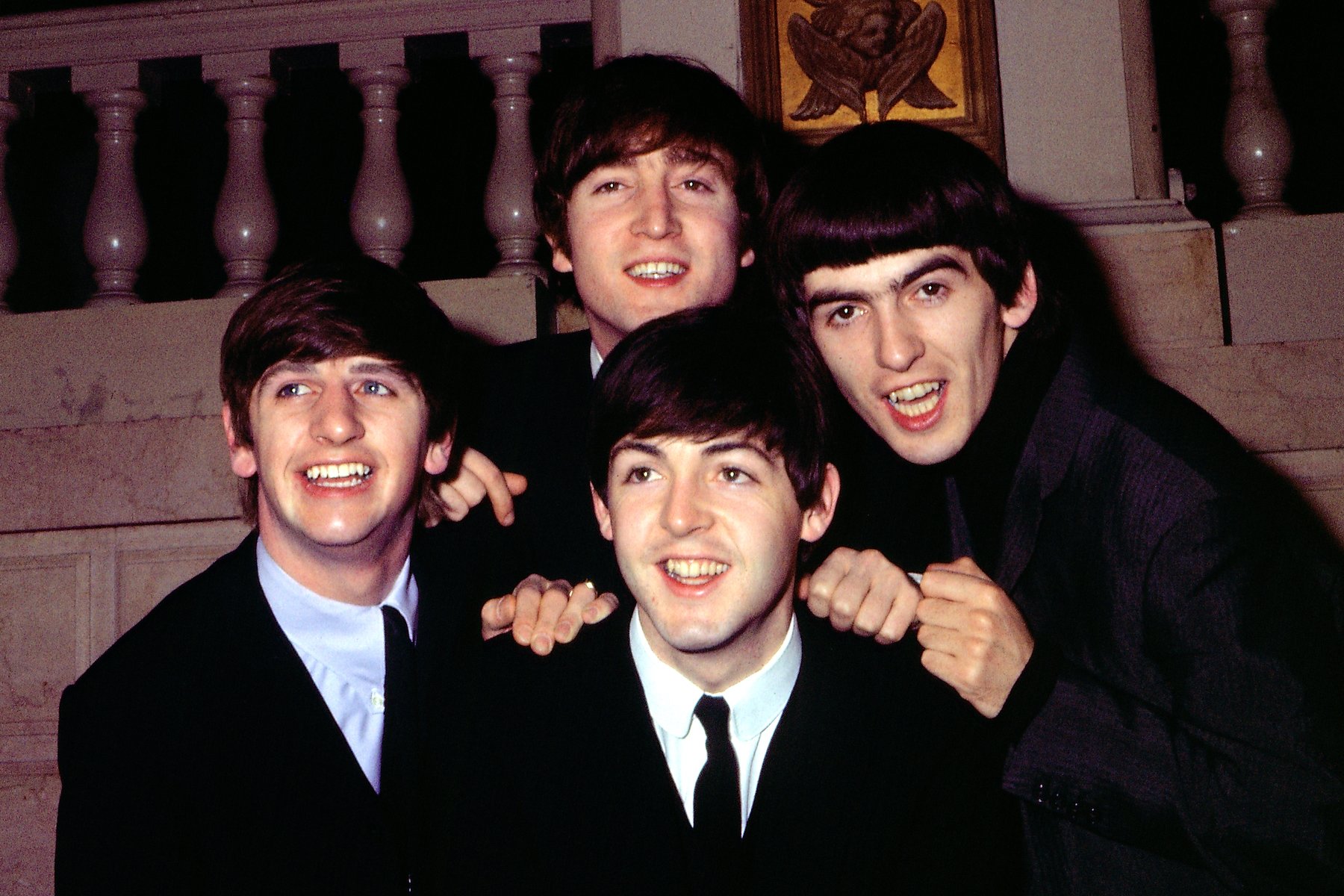 The Beatles (Ringo Starr, John Lennon, Paul McCartney, George Harrison) pose for a portrait wearing suits in circa 1964