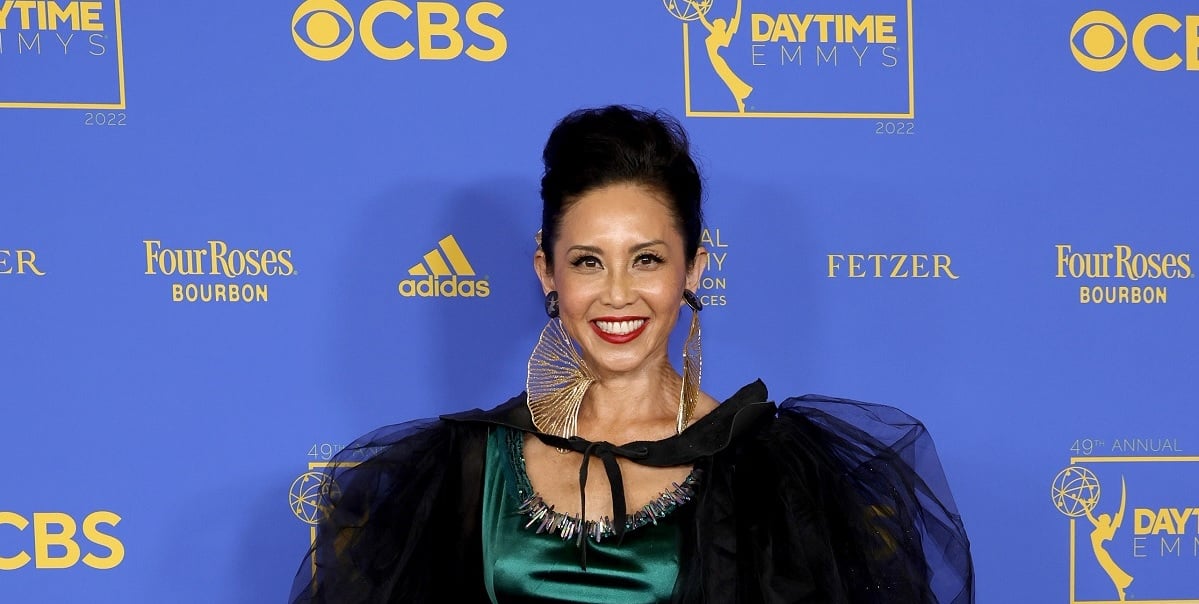 'The Bold and the Beautiful' star Naomi Matsuda wearing a green dress and black wrap at the 2022 Daytime Emmys.