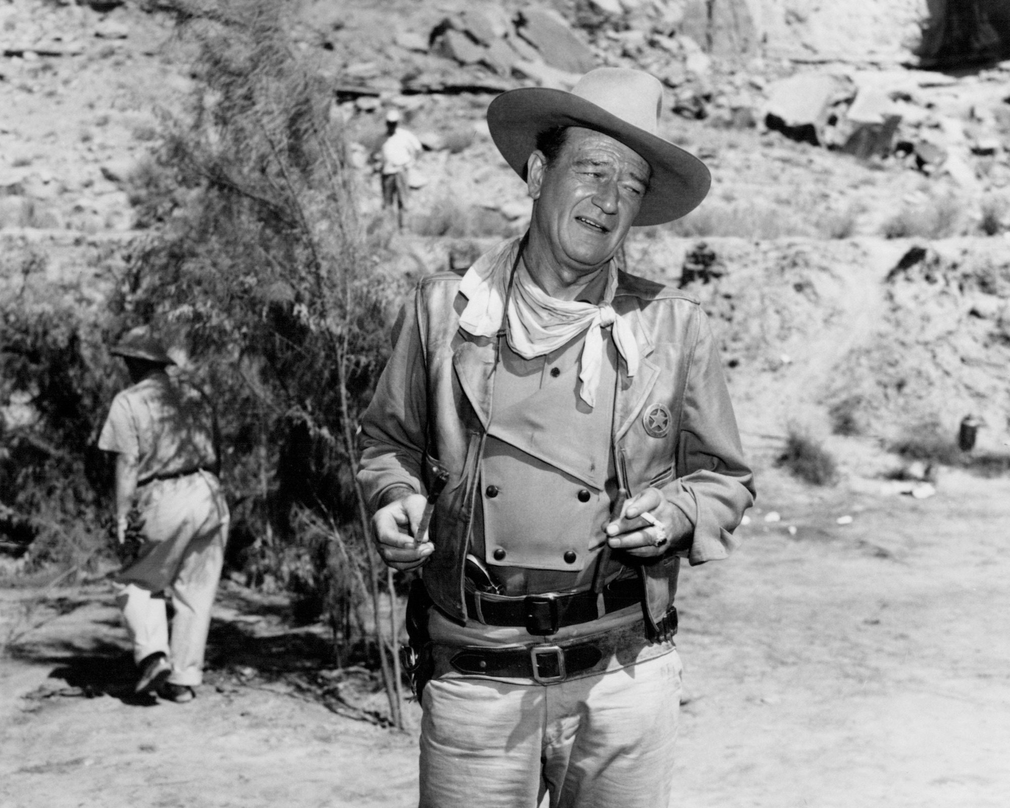 'The Comancheros' actor John Wayne, whose grave is in Newport Beach. He's wearing his Western costume, standing in front of a tree.