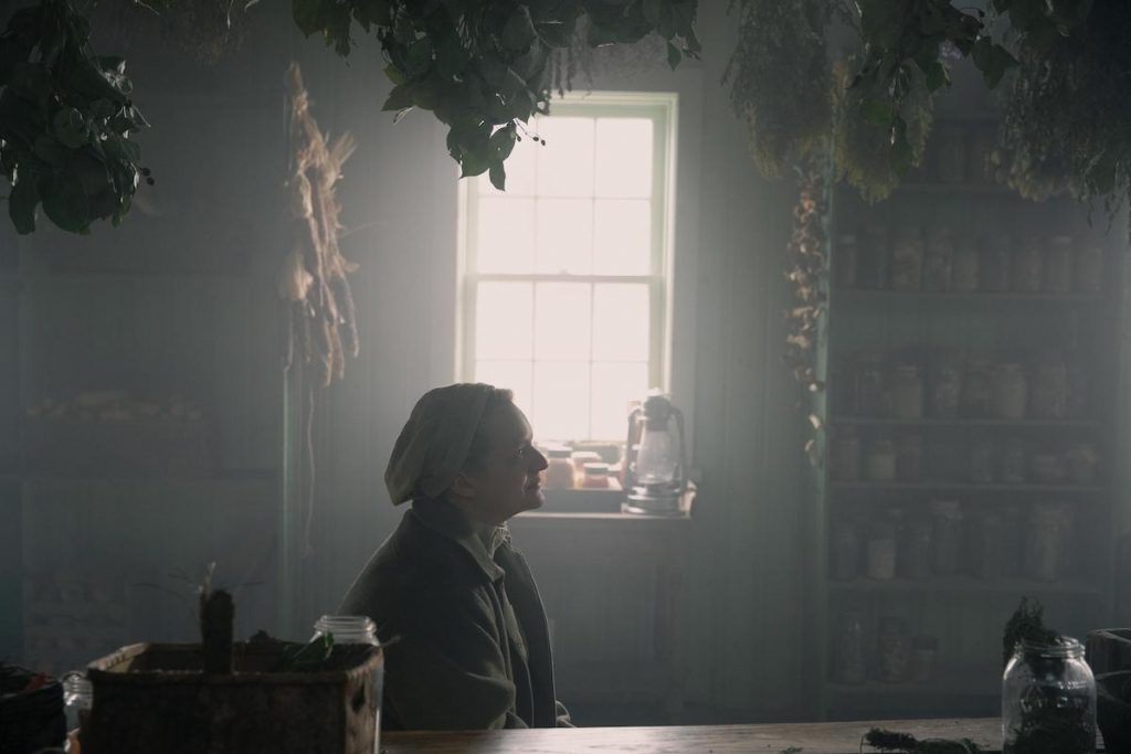 'The Handmaid's Tale' scene showing Elisabeth Moss as June sitting in front of a window