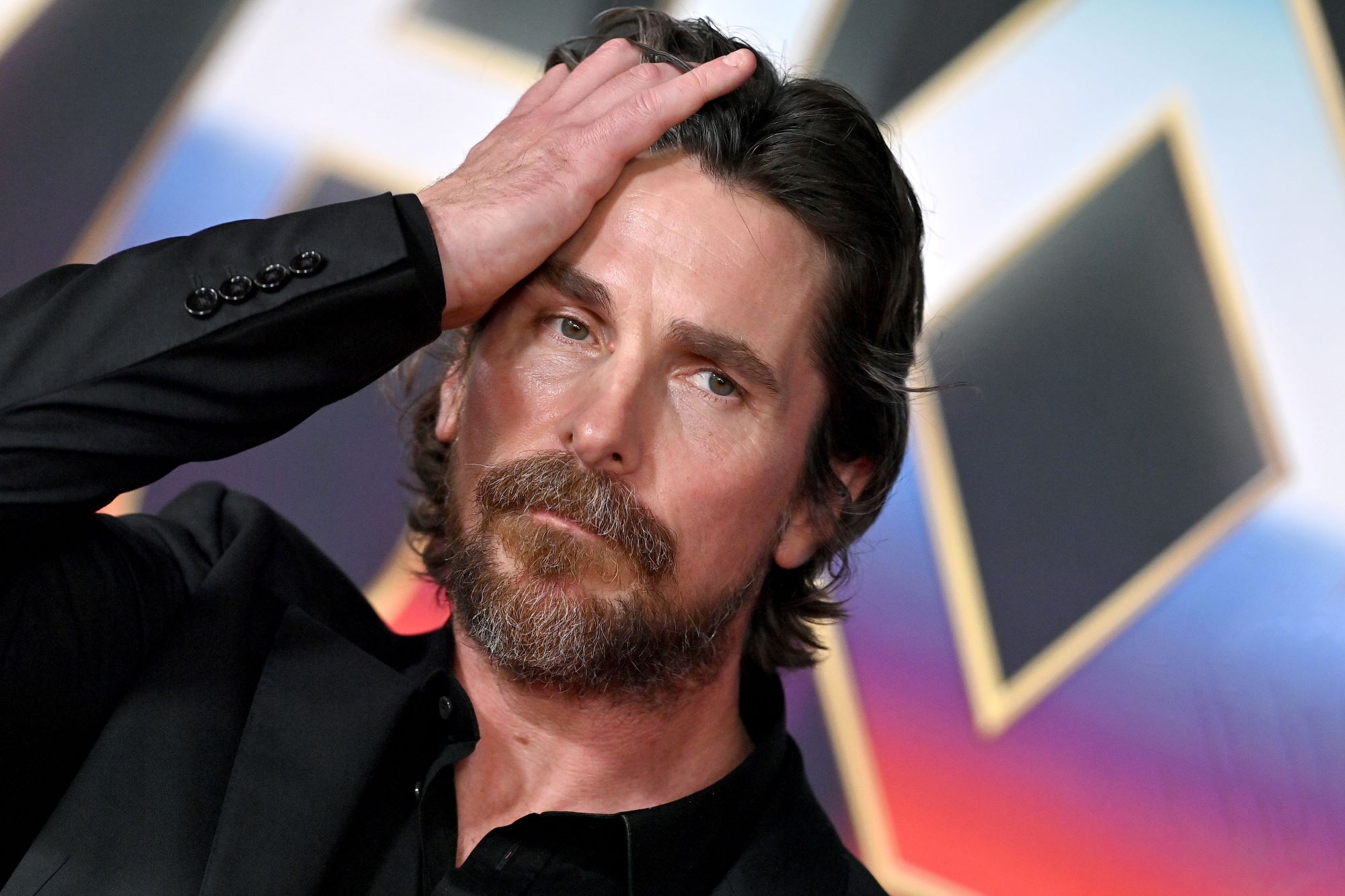 Christian Bale, who stars in 'Thor: Love and Thunder,' wears a black suit
