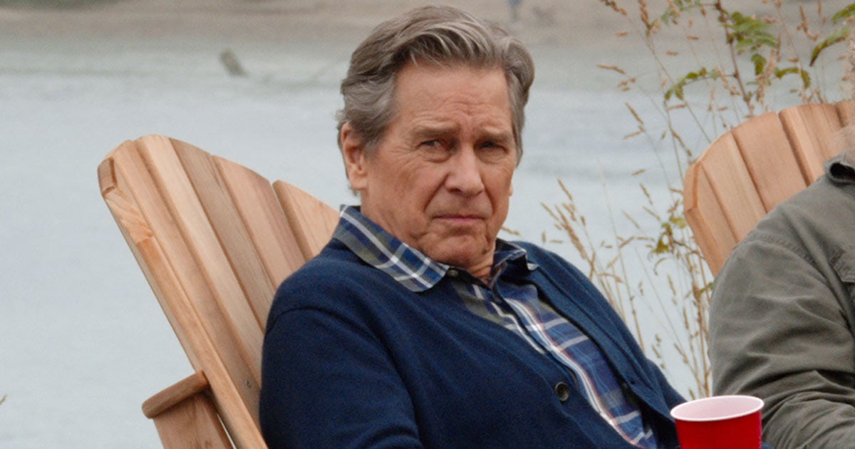 Tim Matheson as Doc Mullins sitting by the river and holding a cup in 'Virgin River' |