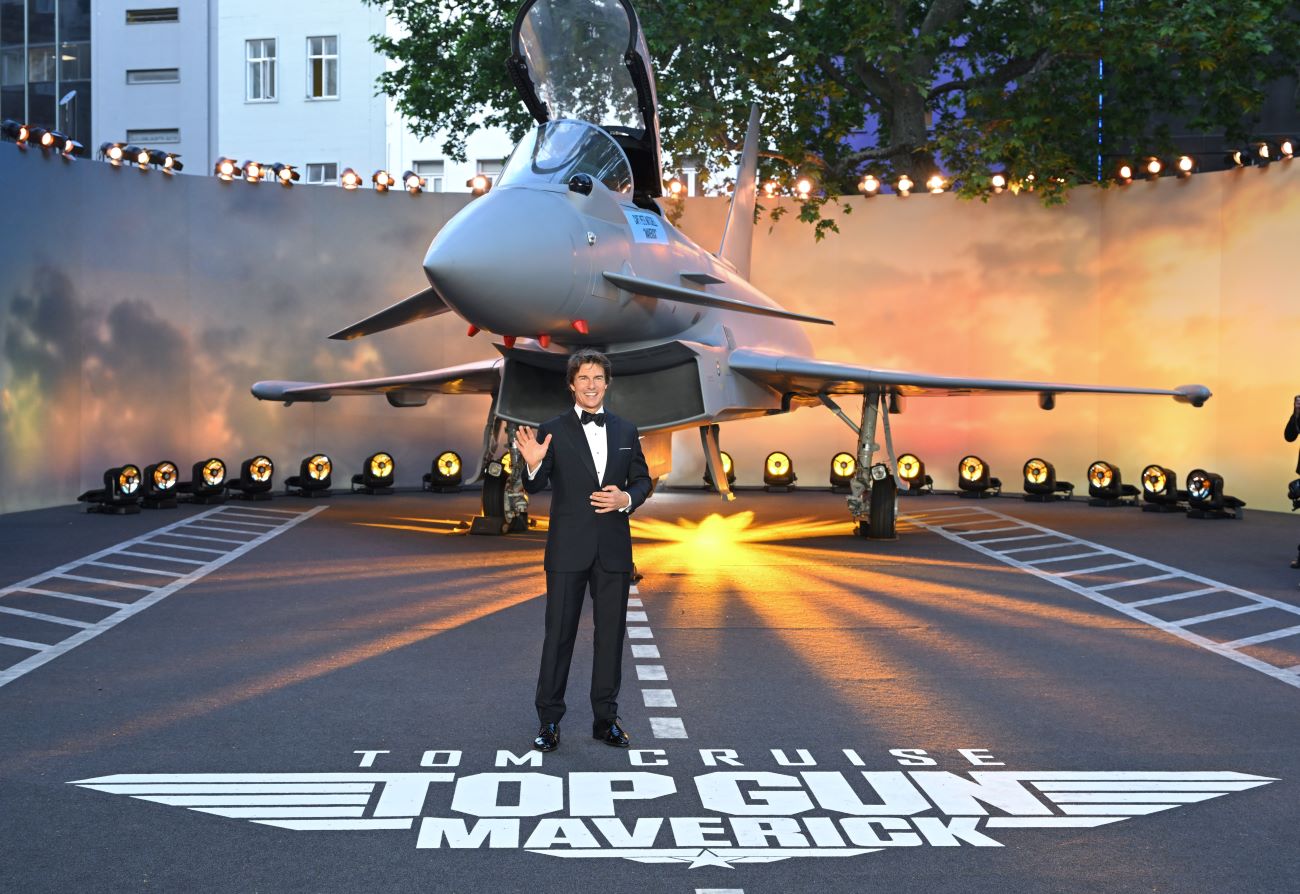 Tom Cruise stands in front of a plane at the premiere of the Paramount movie Top Gun: Maverick.