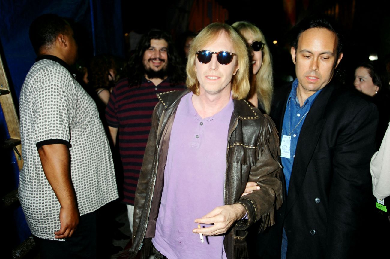 Tom Petty wears sunglasses and a leather jacket and walks through a crowd at the MTV Video Music Awards.