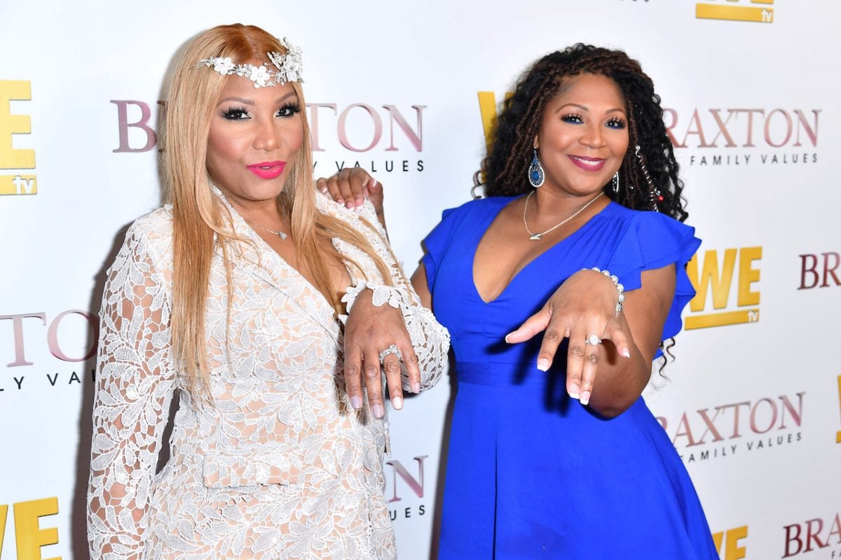 Traci and Trina Braxton pose on the red carpet; Trina says losing a loved one prepared her for the death of her sister Traci